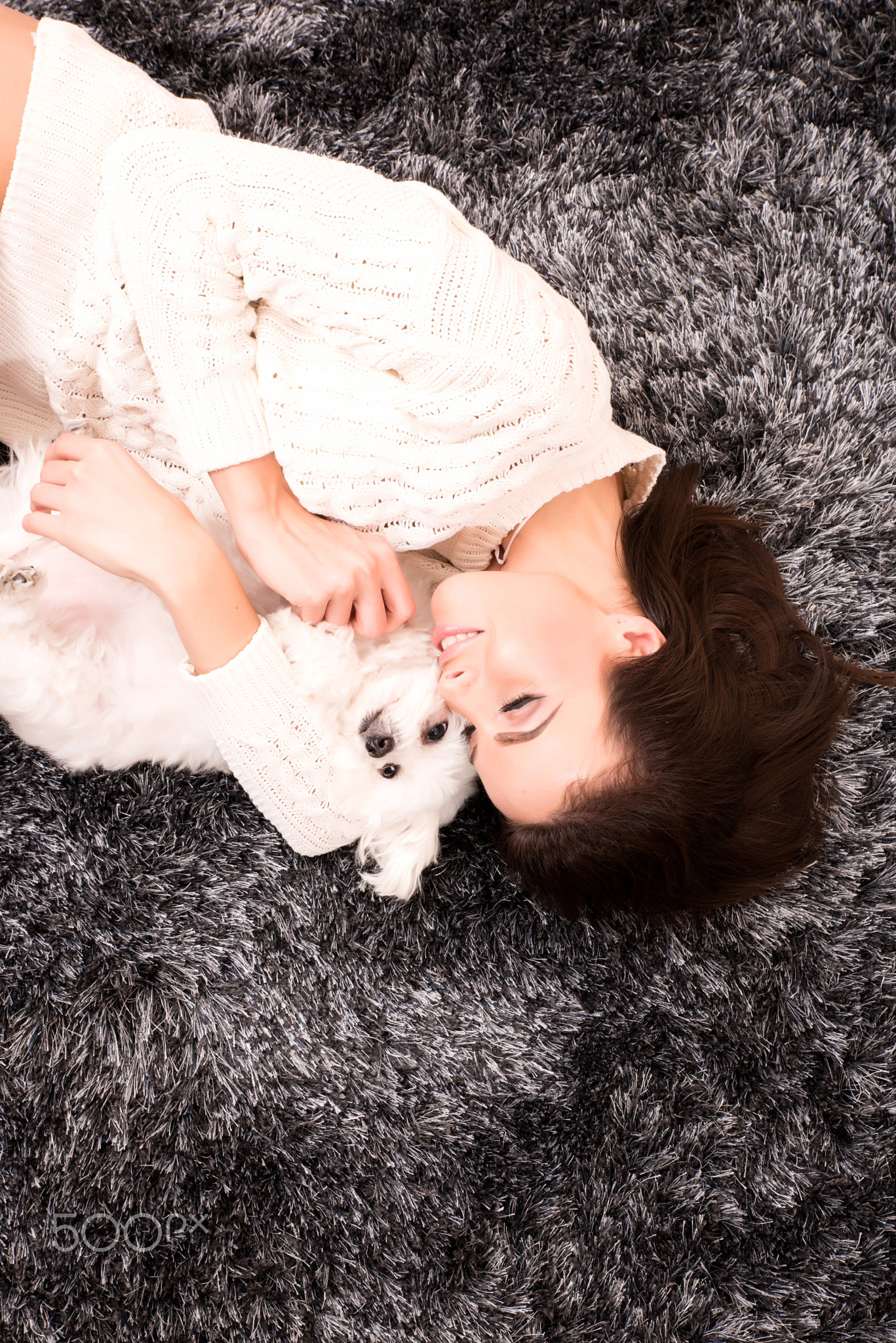 Young beautiful woman hugging her puppy