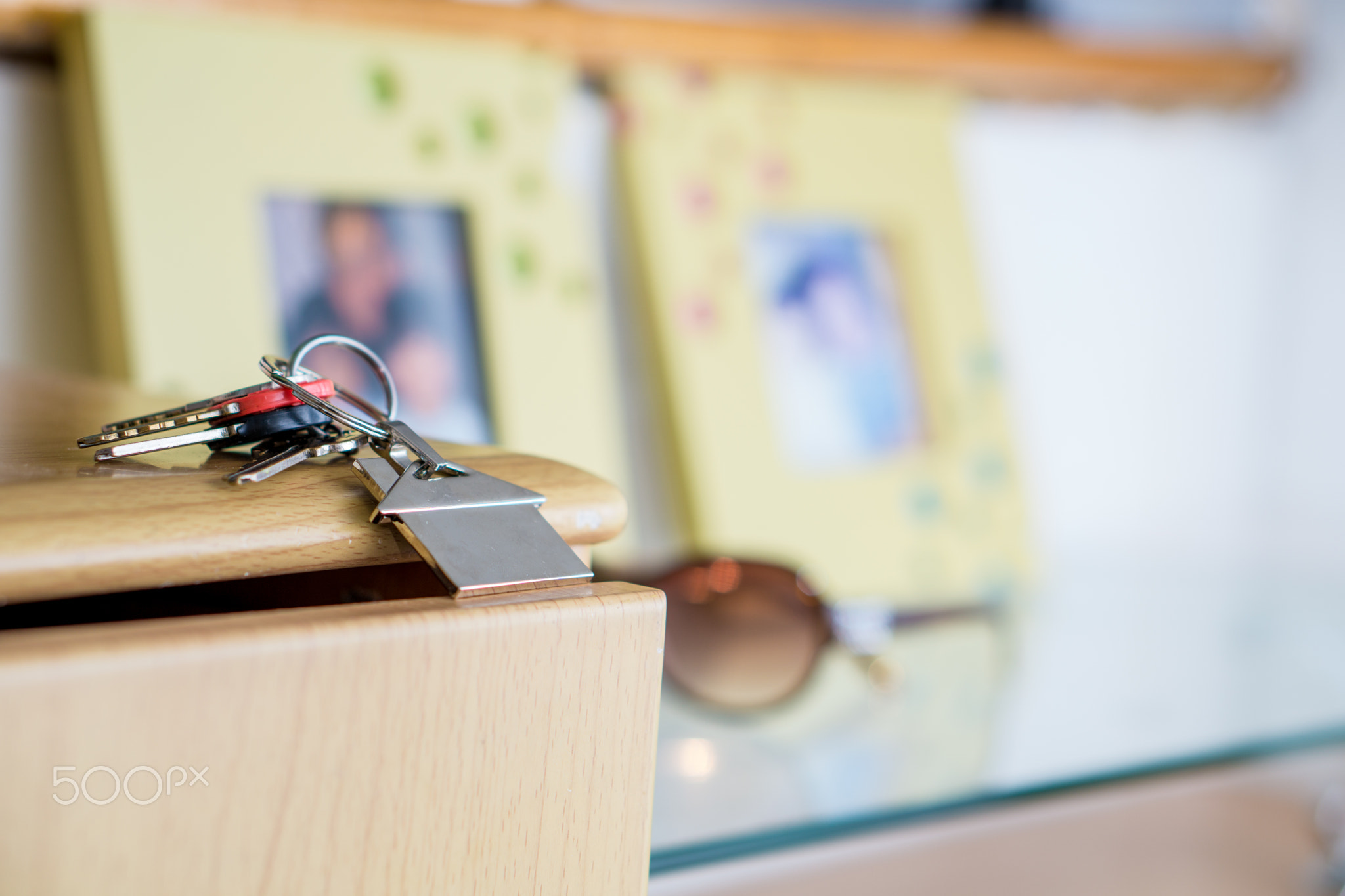 key and sunglass on a glass top, new home concept