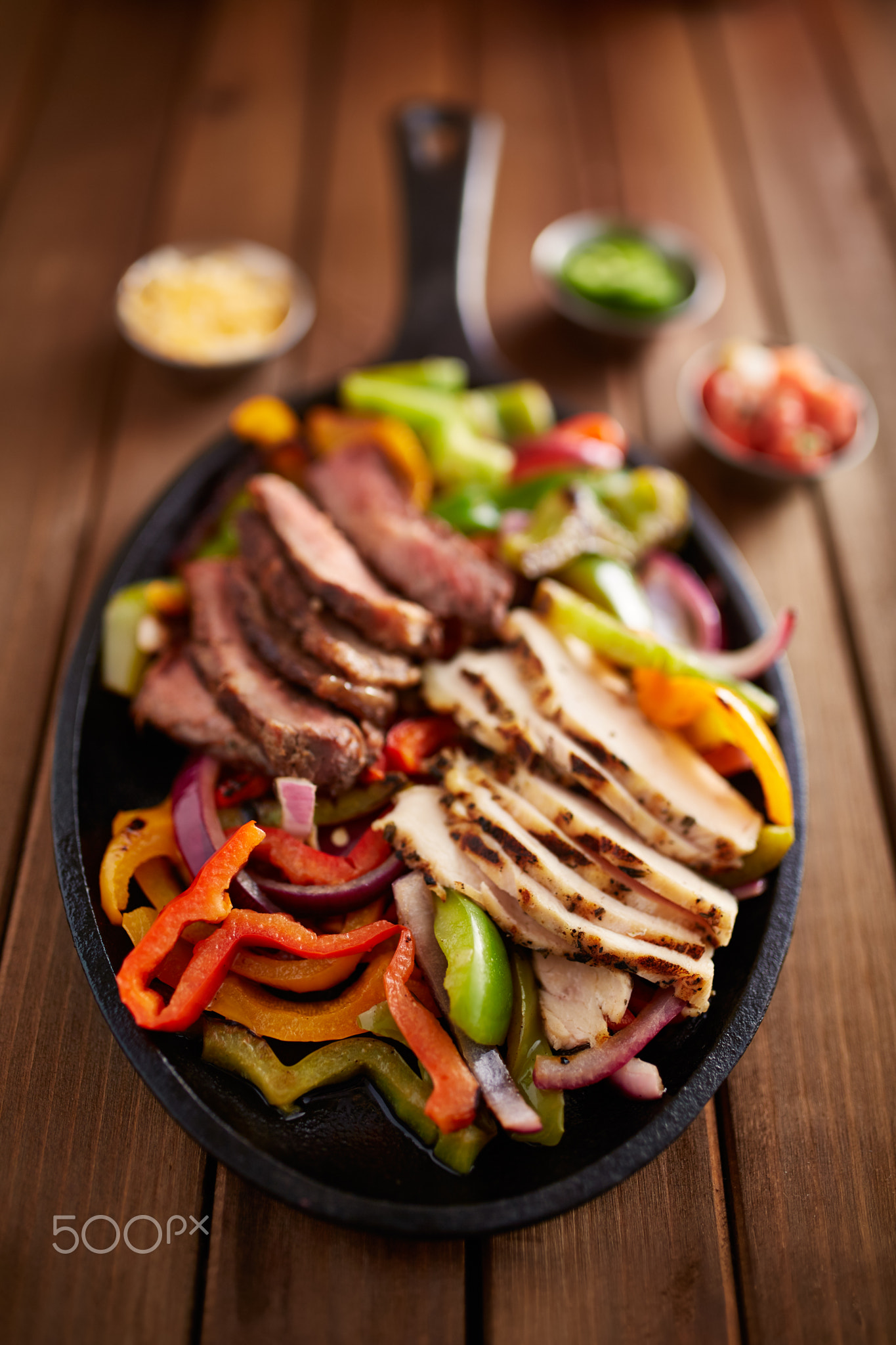 mexican steak and chicken fajitas in cast iron skillet