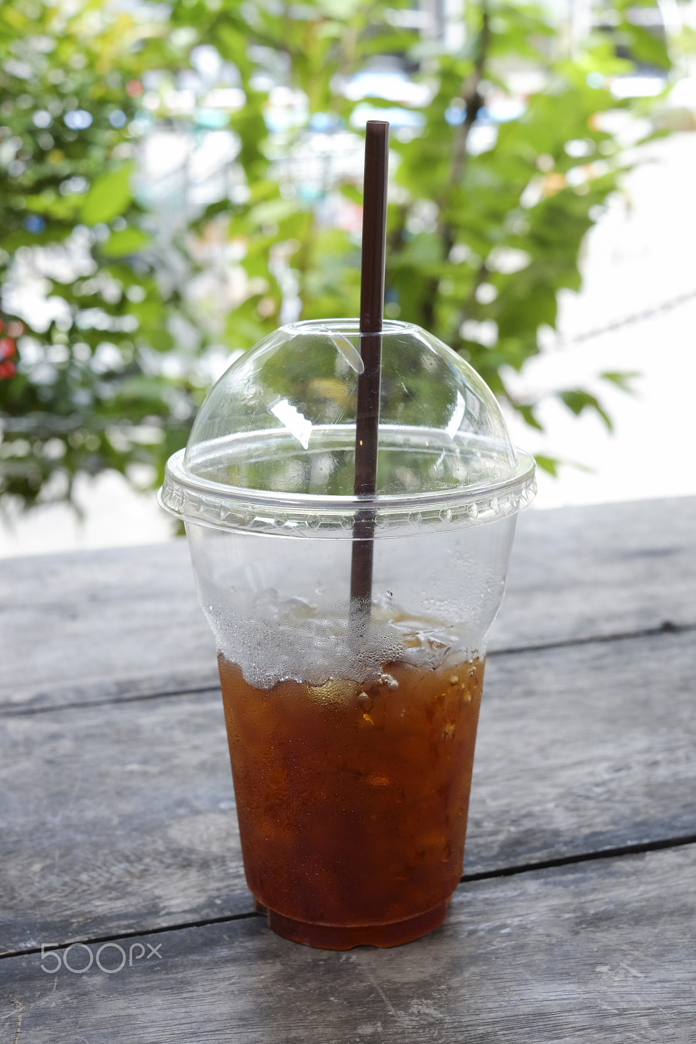 Delicious ice coffee americano with coffee glass lid and straws