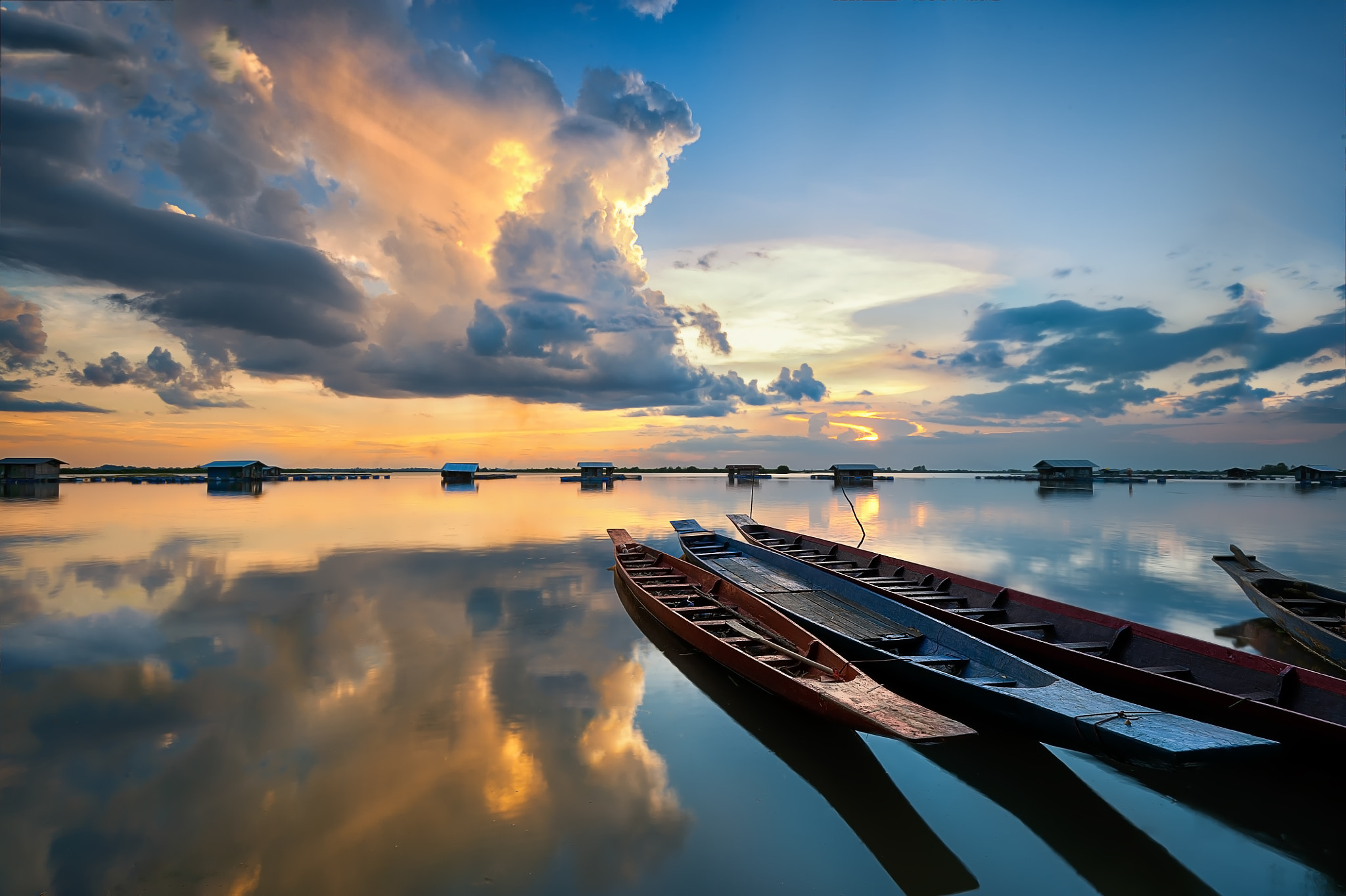 Fishing boat and reflexion of clouds on Sunset