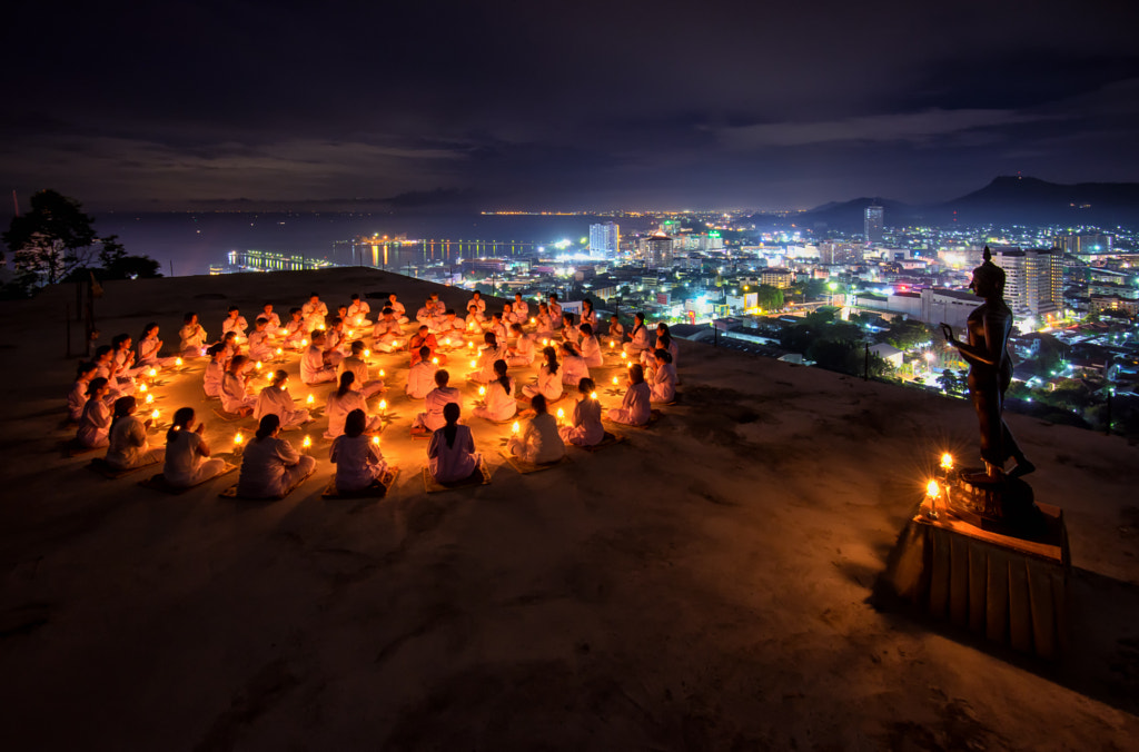 Thai monks and buddhist prayers and meditation with buddha statue among many candle by Phattana Sangsawang on 500px.com