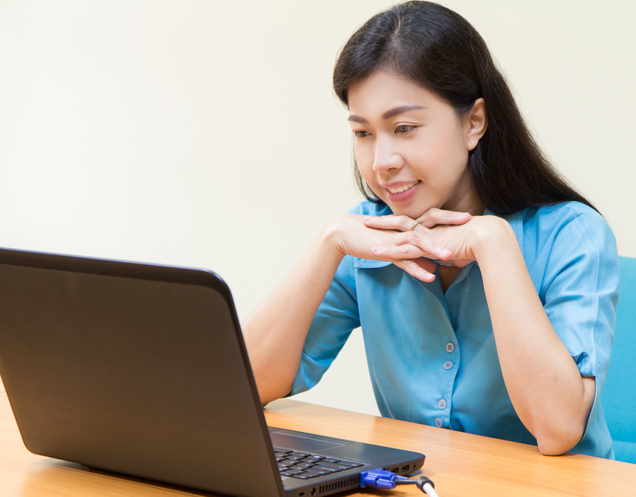 Smiling Young Black Woman using her laptop.