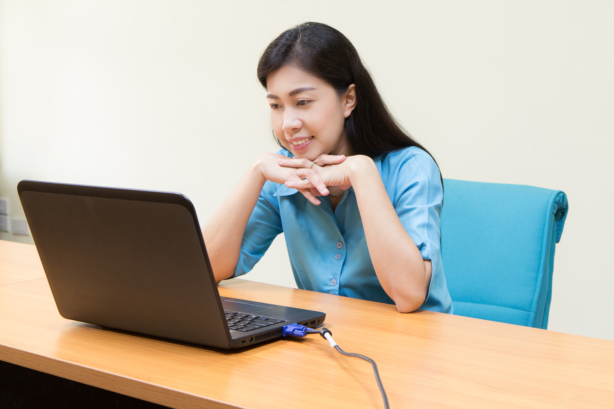 Smiling Young Black Woman using her laptop.