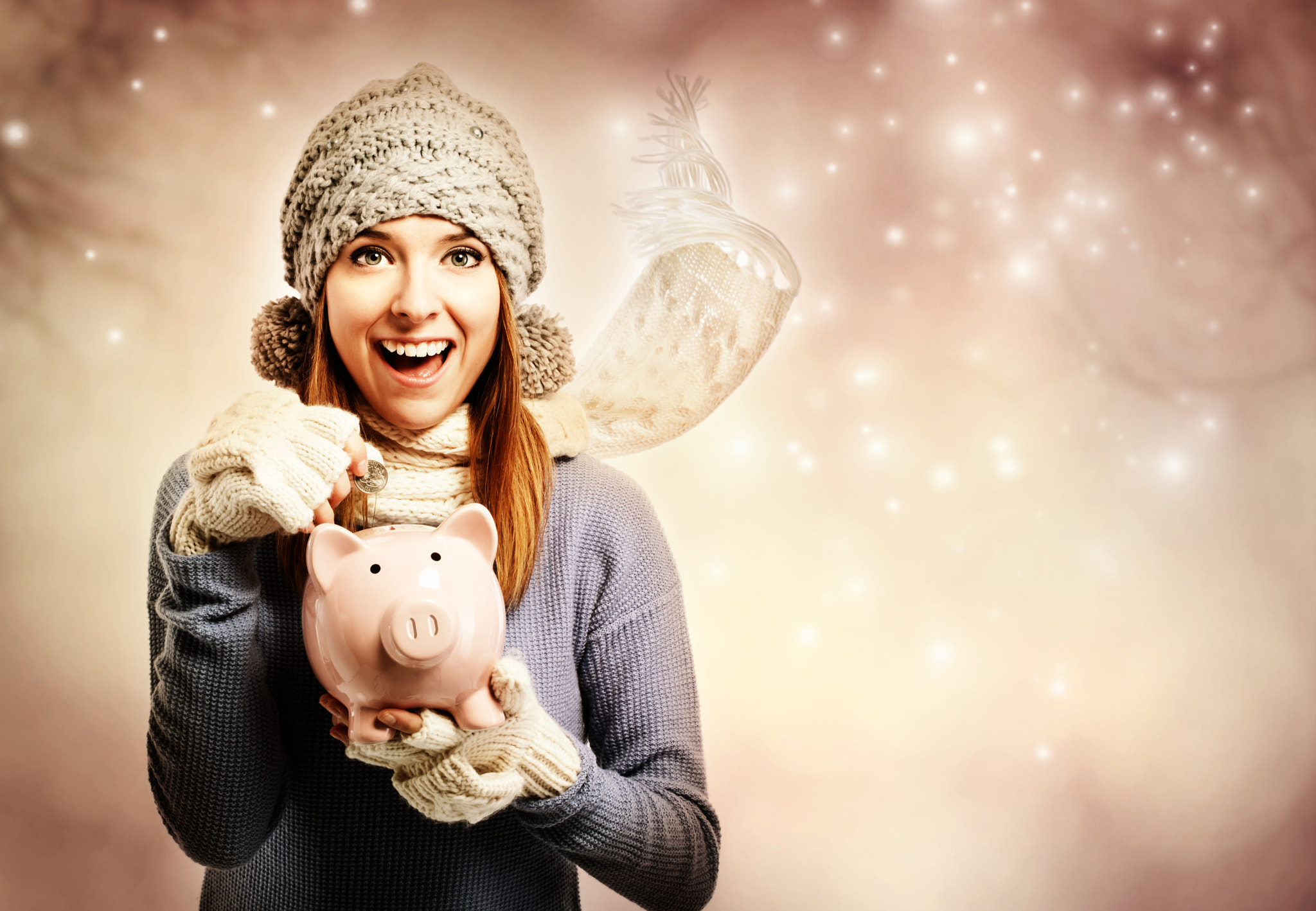 Happy young woman depositing money into her piggy bank