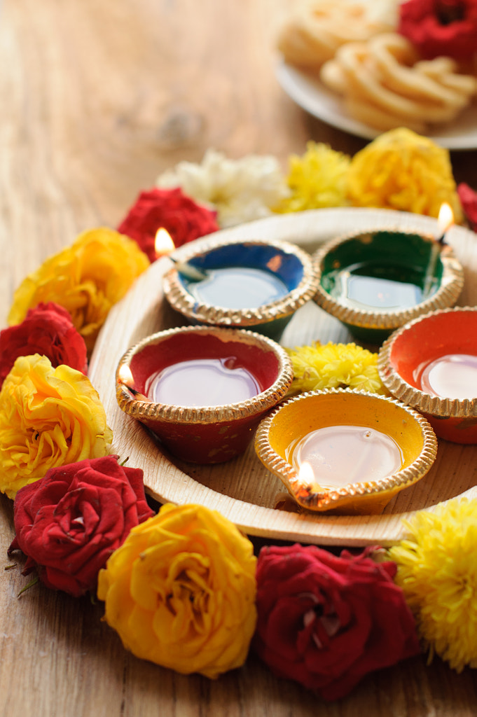Diwali Diyas with flowers by Anshu A on 500px.com