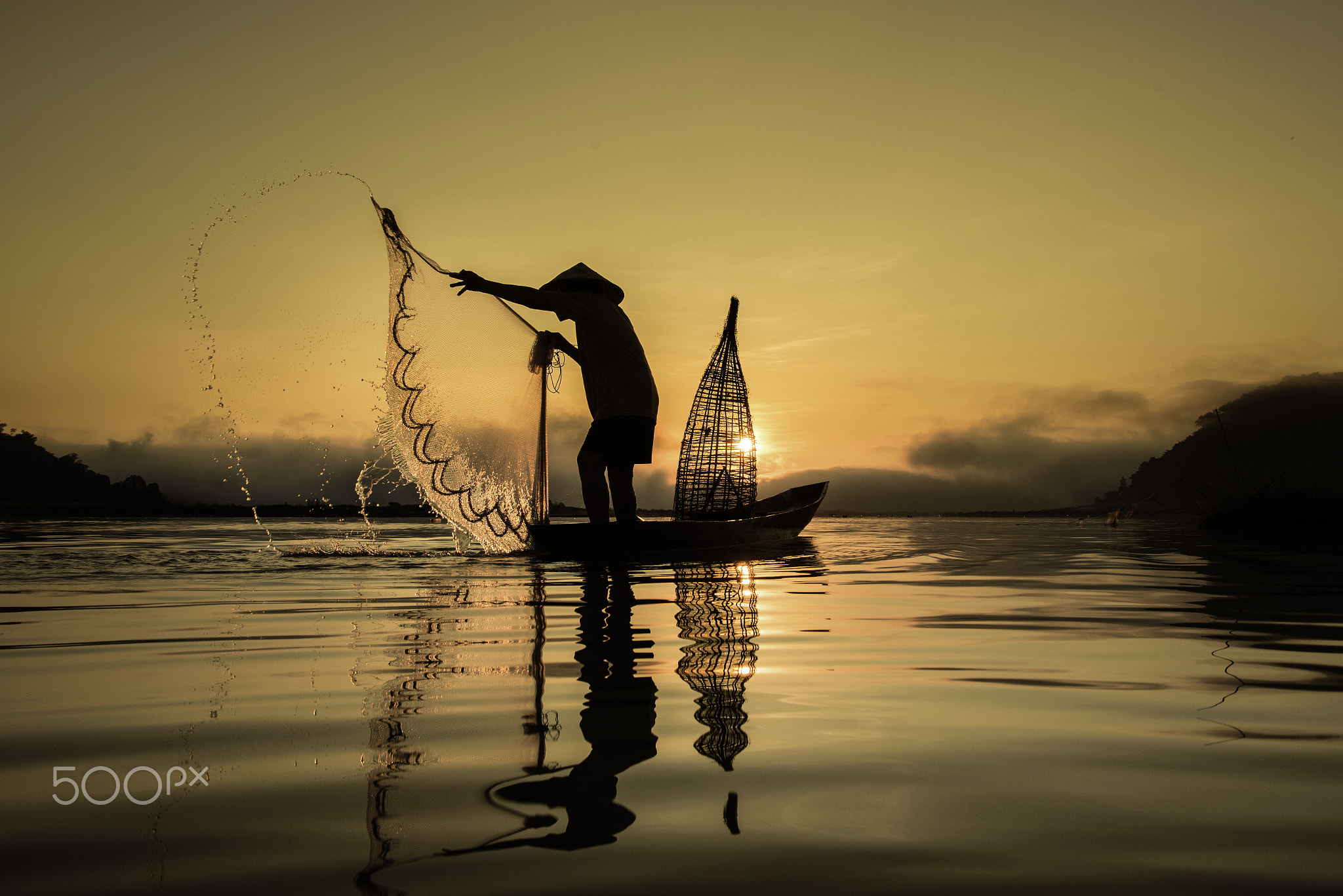 Fishermen in action when fishing in the lake , Thailand