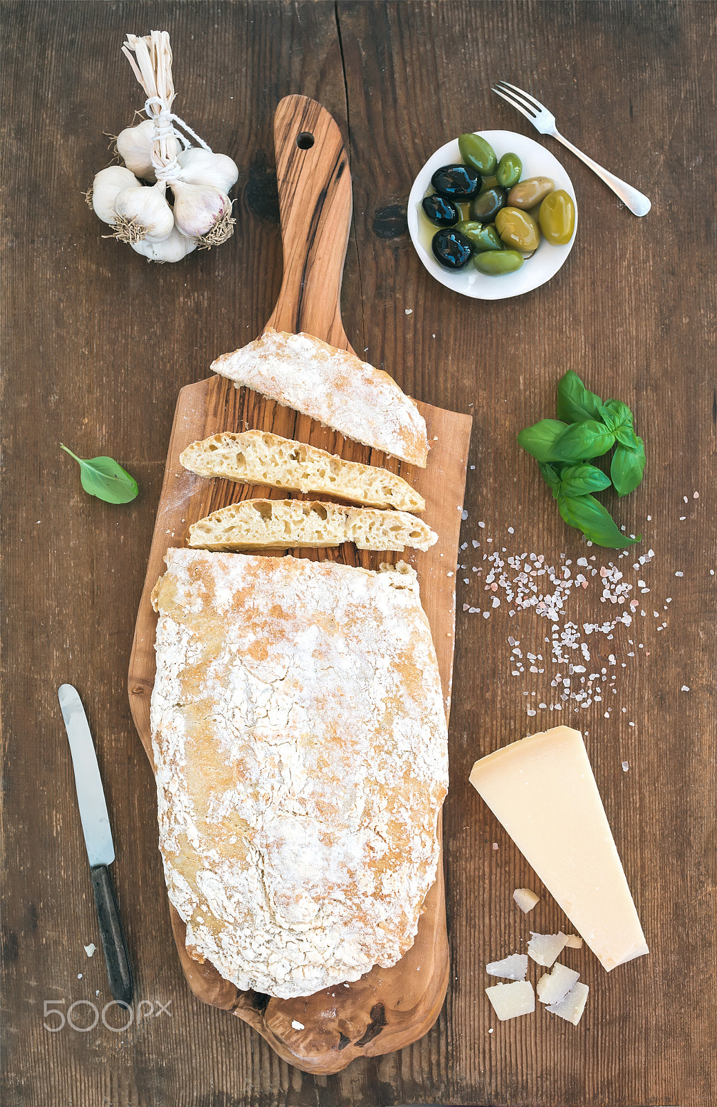 Nikon D610 + ZEISS Distagon T* 35mm F2 sample photo. Freshly baked ciabatta bread with garlic, mediterranean olives, basil and parmesan cheese on serving photography