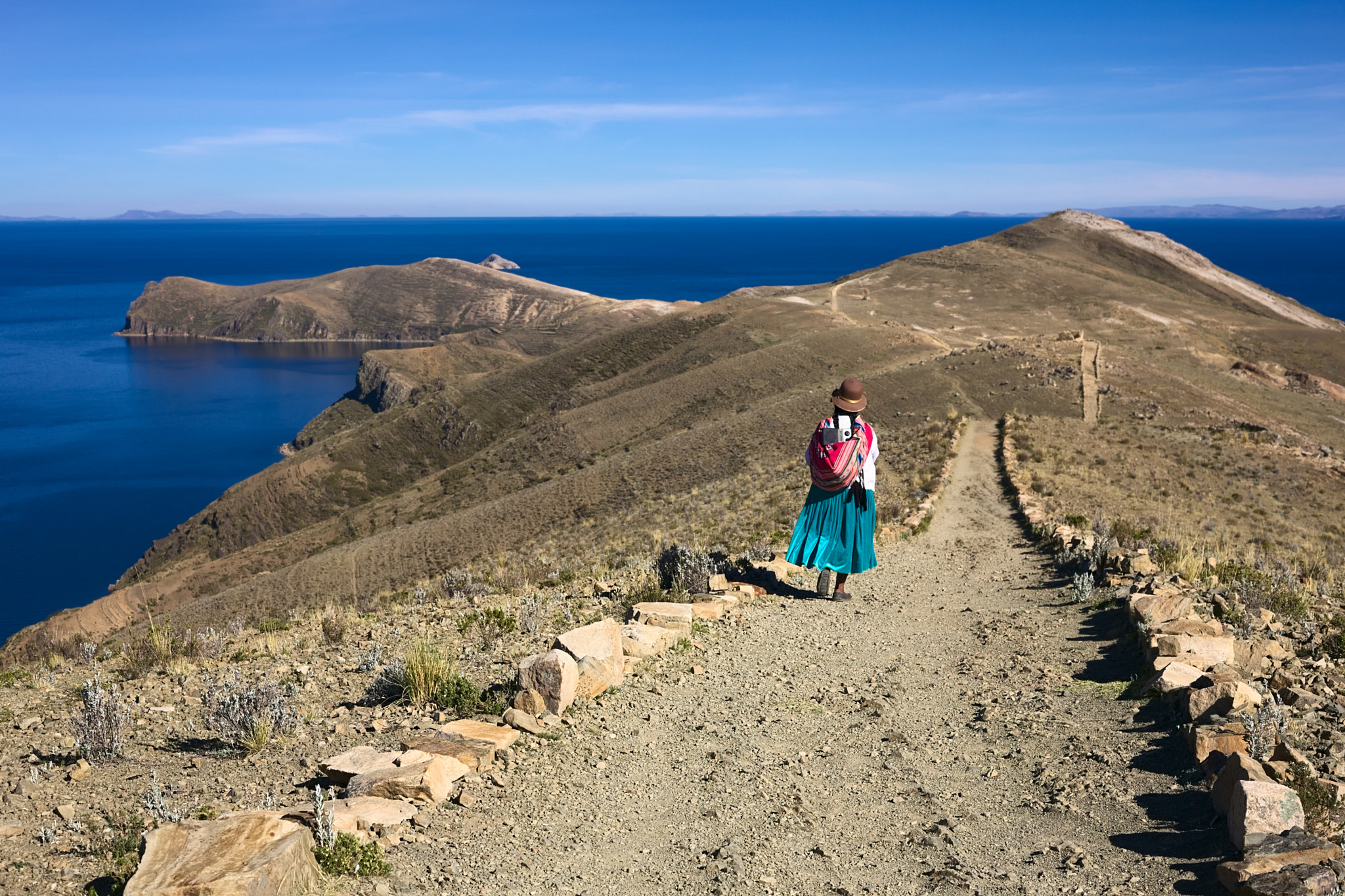 Woman Walking on Path on Isla del Sol in Lake Titicaca, Bolivia