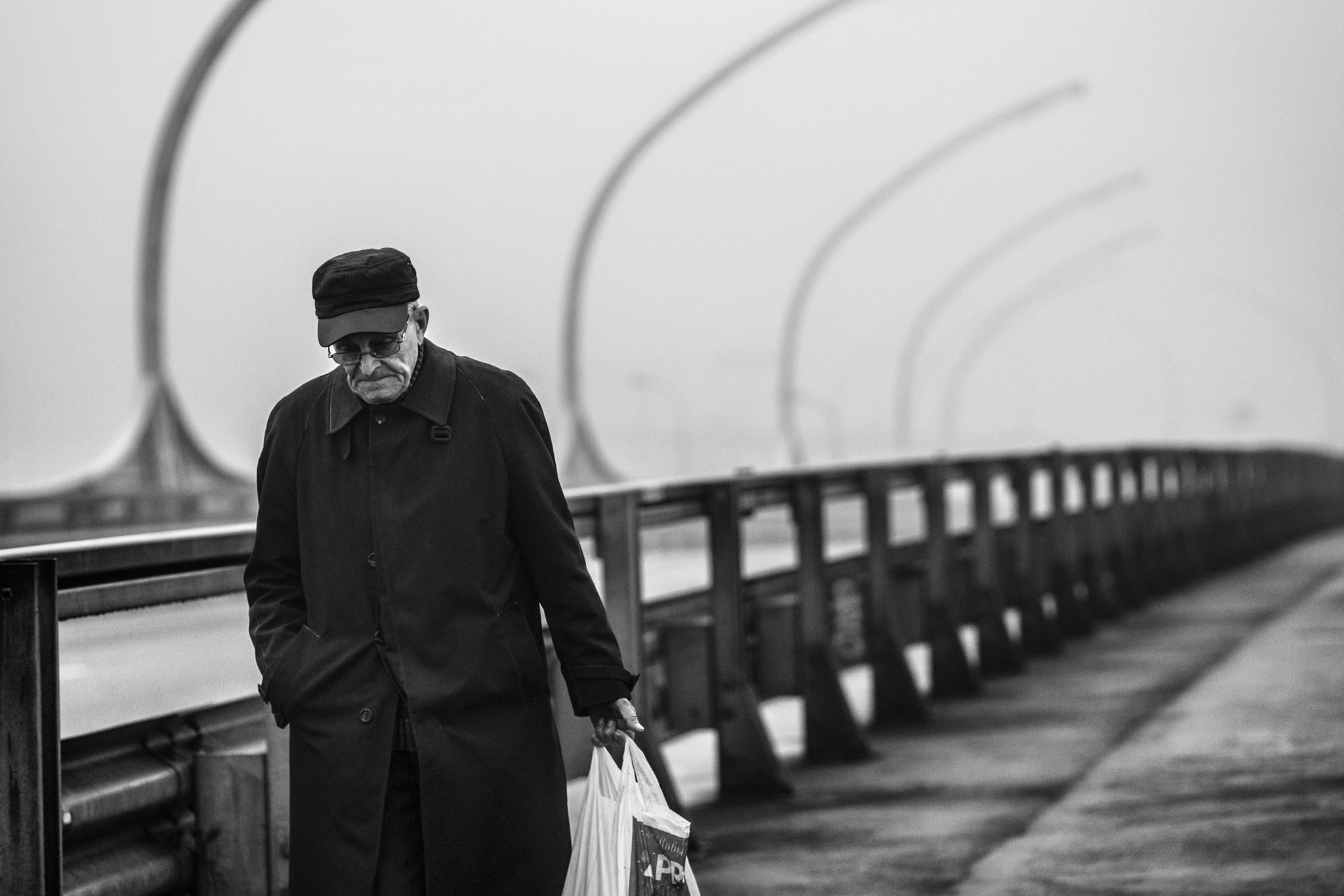 Sony SLT-A77 + Sigma 85mm F1.4 EX DG HSM sample photo. A man walking along a foggy road photography