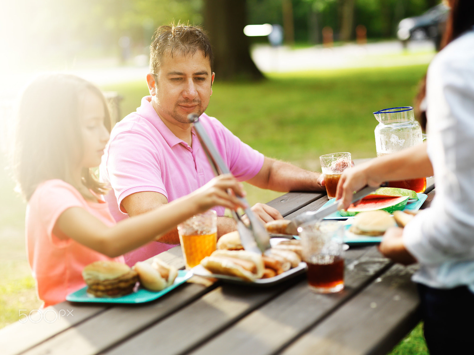 HC 100 sample photo. Father and daughter eating together at barbecue cookout photography