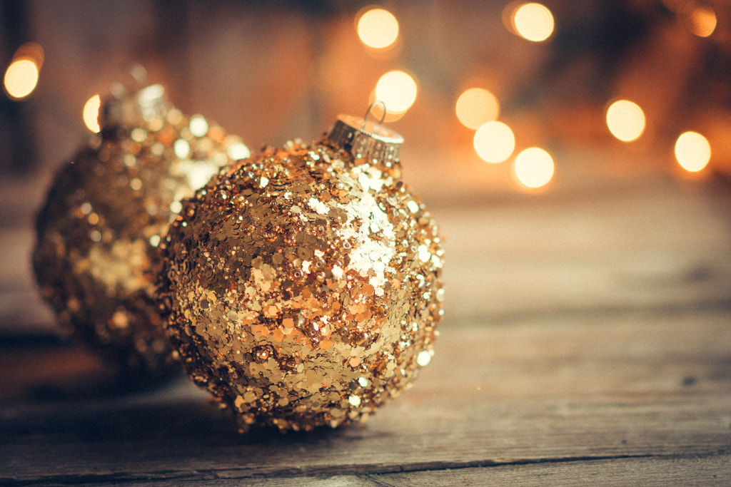 Golden christmas ornaments on rustic background by Alena Haurylik on 500px.com