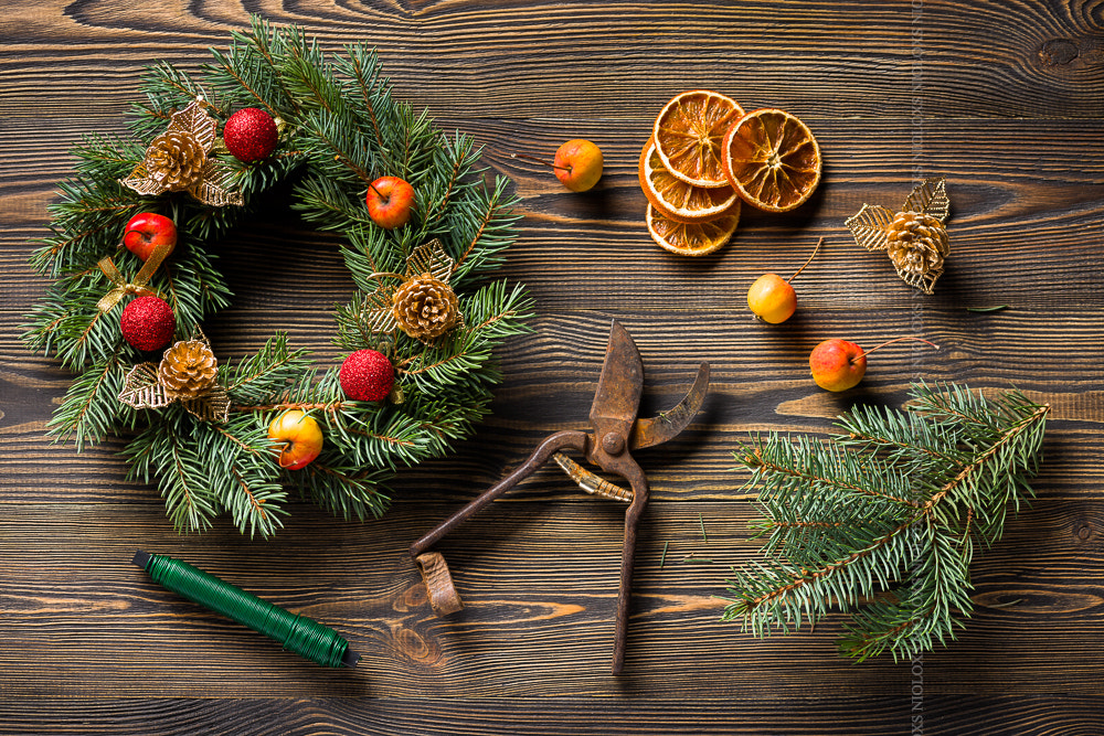 Christmas wreath on brown wooden table top view