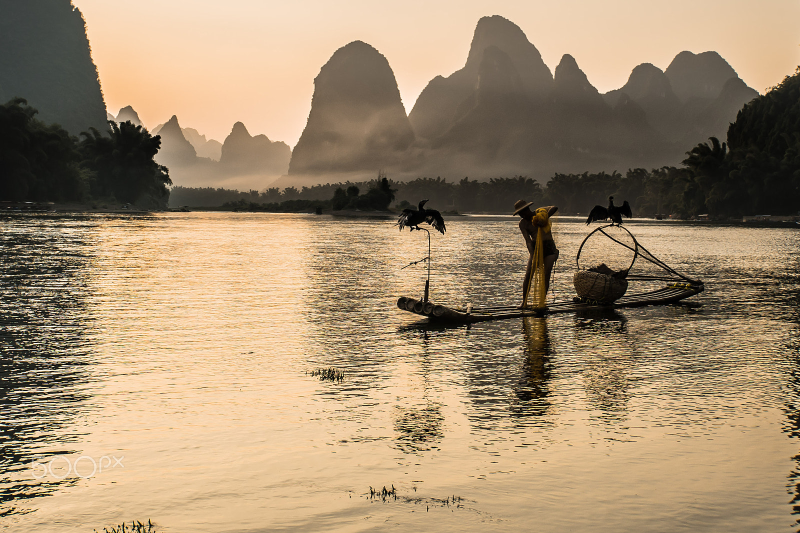 Sony E 18-200mm F3.5-6.3 OSS LE sample photo. Cormorant fisherman at dusk photography