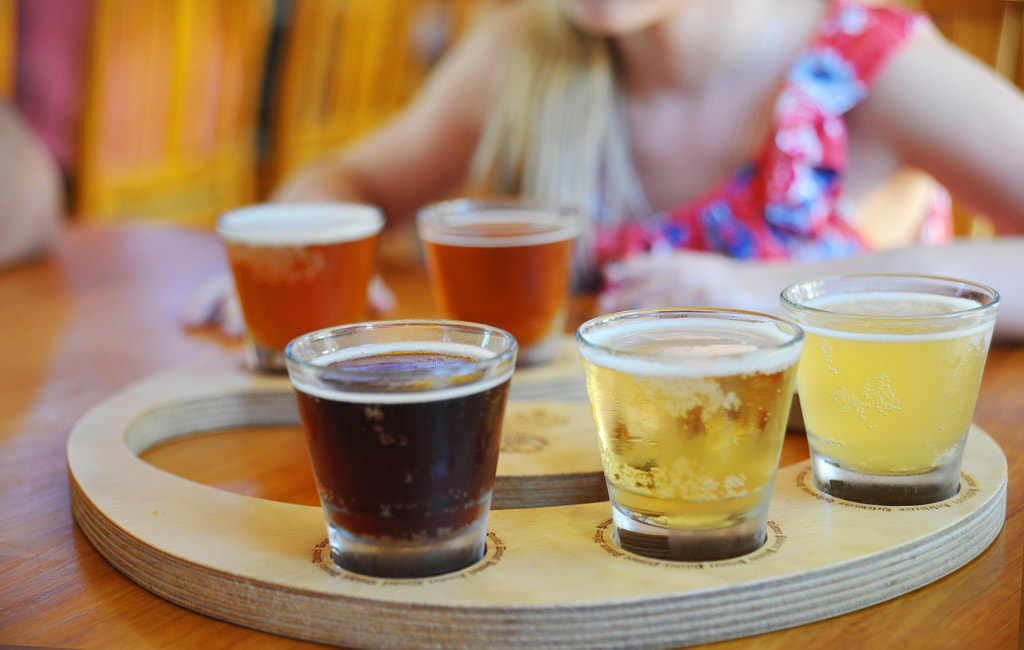 Craft beers in a sampler tray at a restaurant by Kira Garmashova on 500px.com