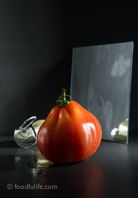 Tomato with mirror and can lid