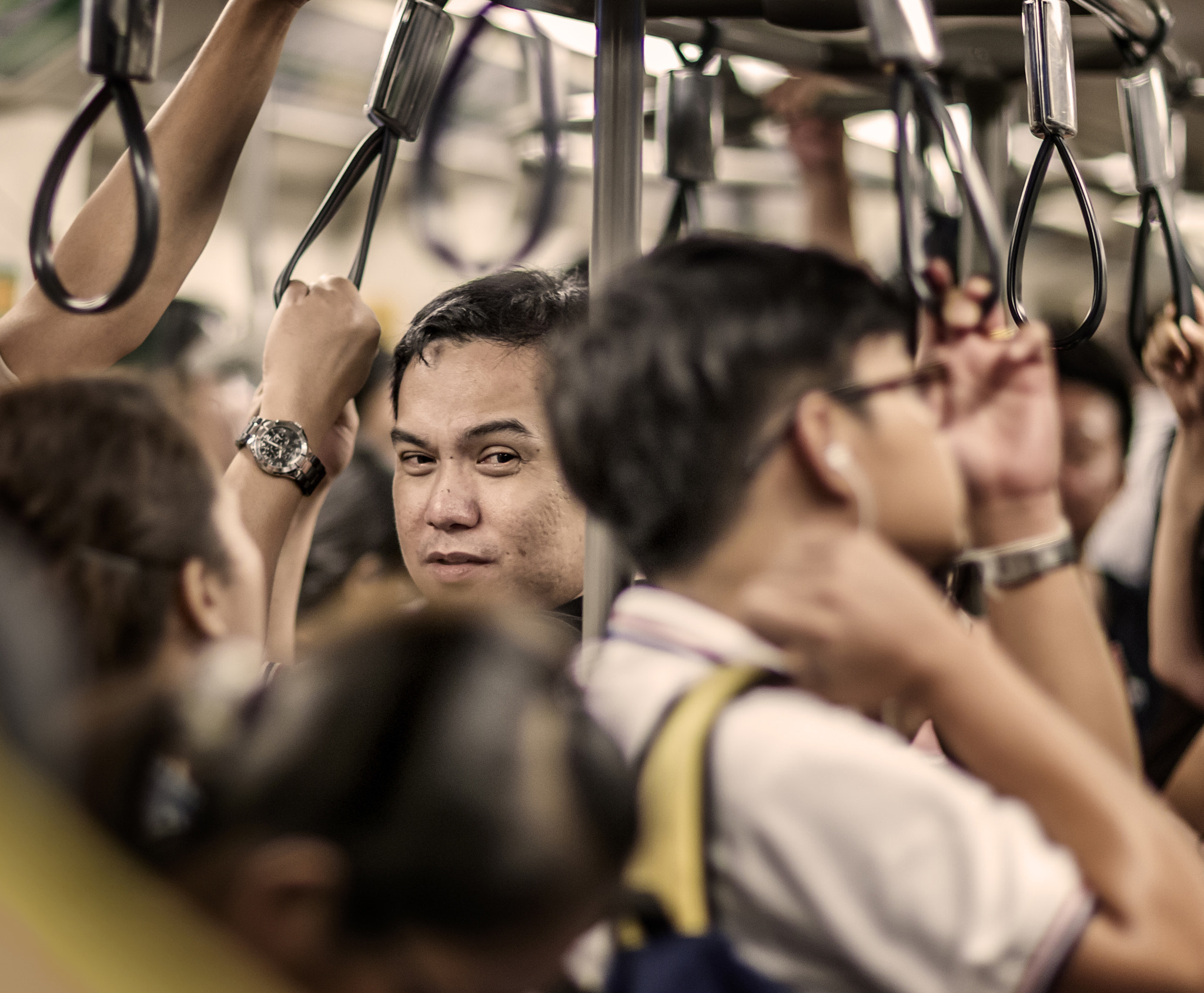 Canon EF 85mm F1.2L II USM sample photo. Look between crowd photography