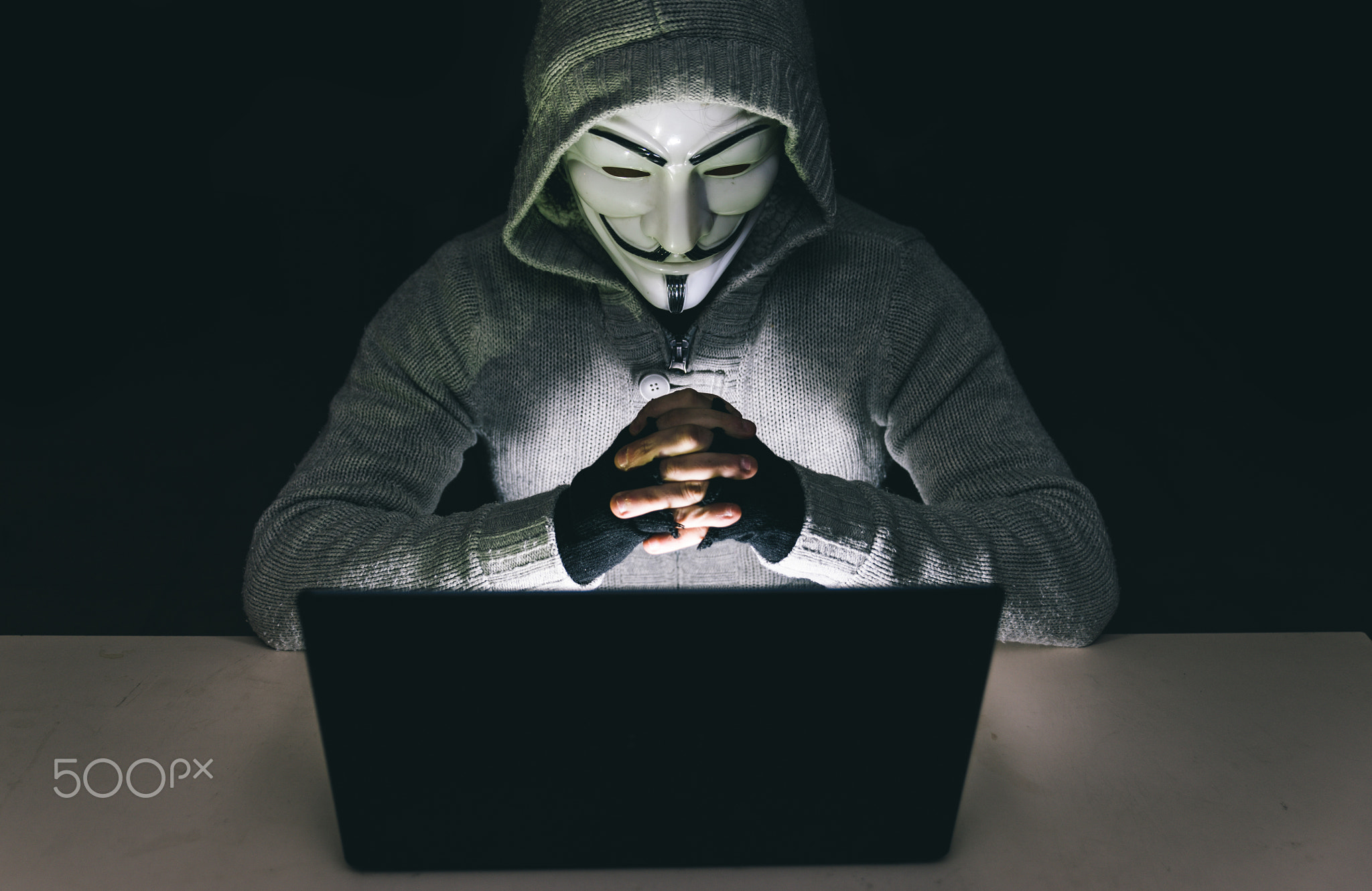 Hacker at work on his computer