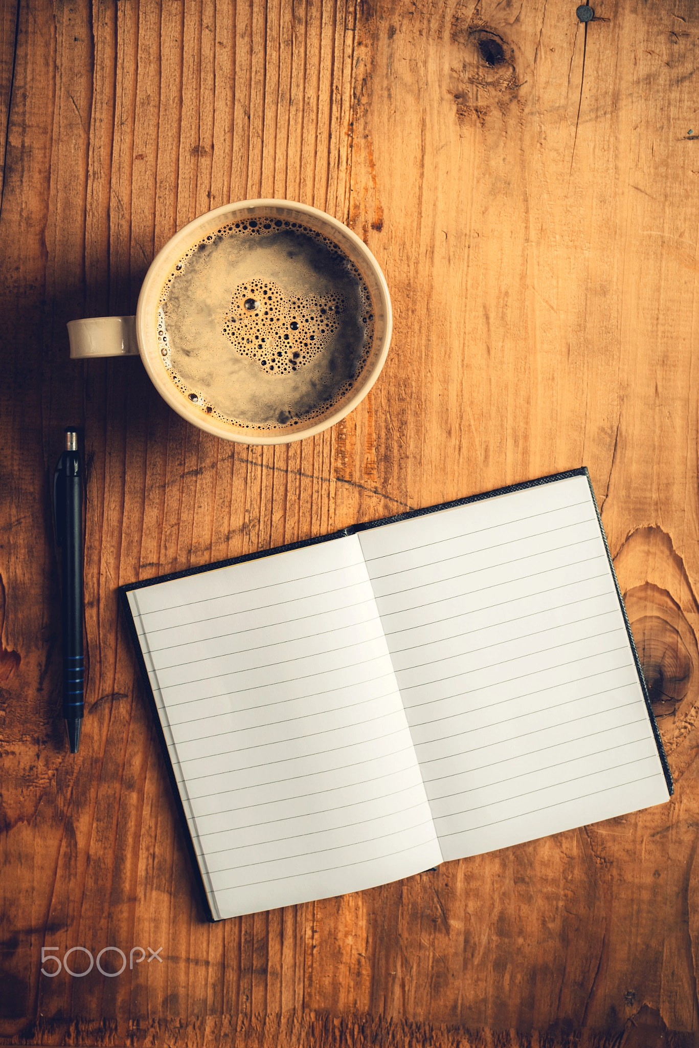 Open notebook, pencil and cup of coffee