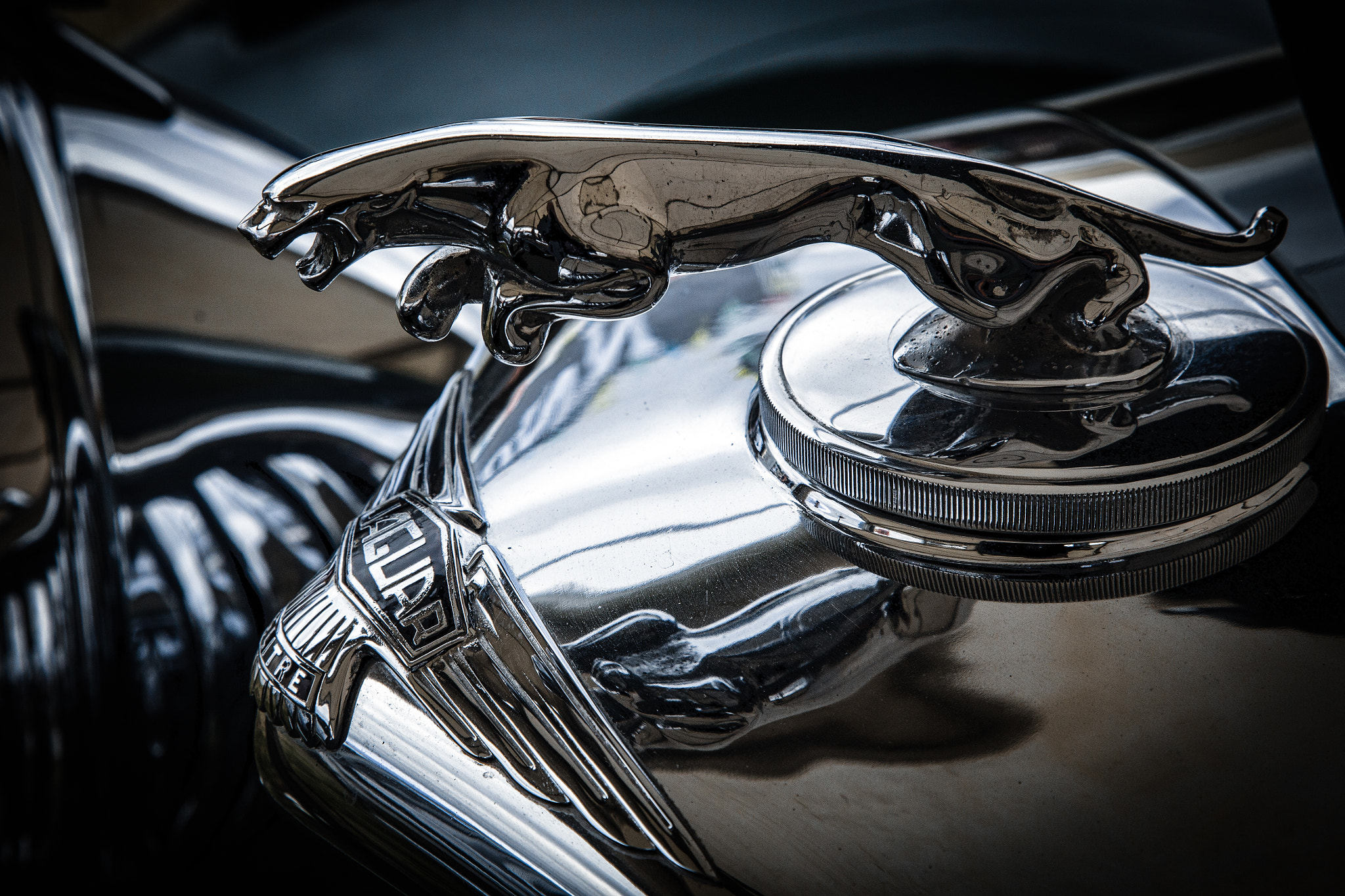 Close-up of an old Jaguar automobile emblem