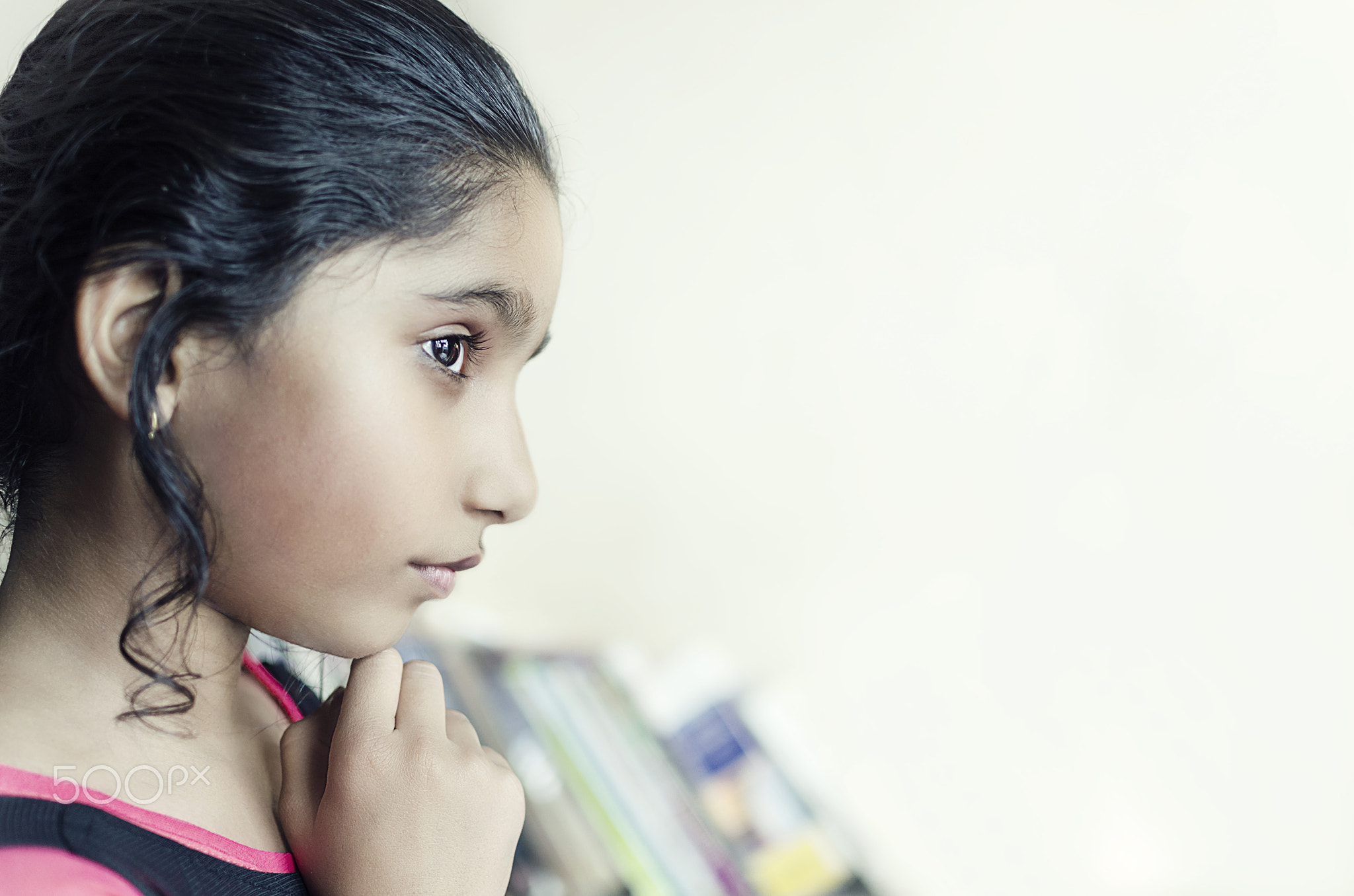 brunette girl child hand on chin