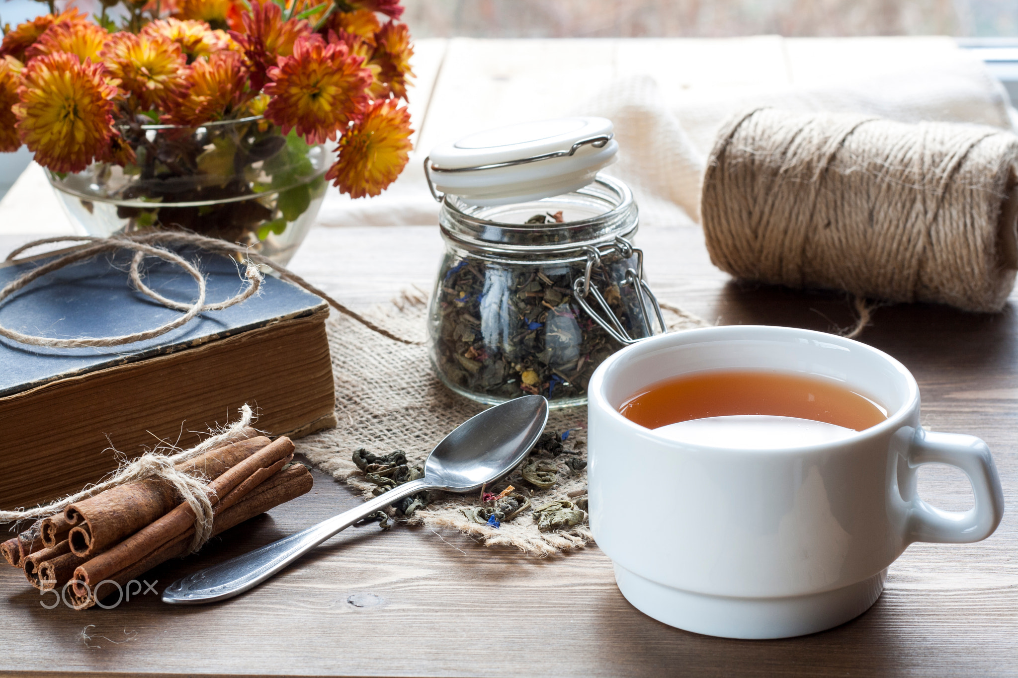 Cup of hot tea with books