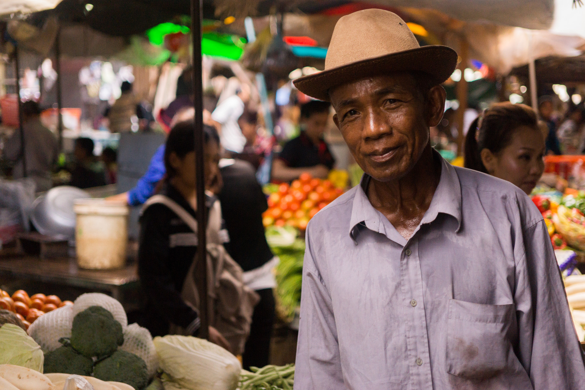 Sony Alpha NEX-7 + E 32mm F1.8 sample photo. Man at the market photography