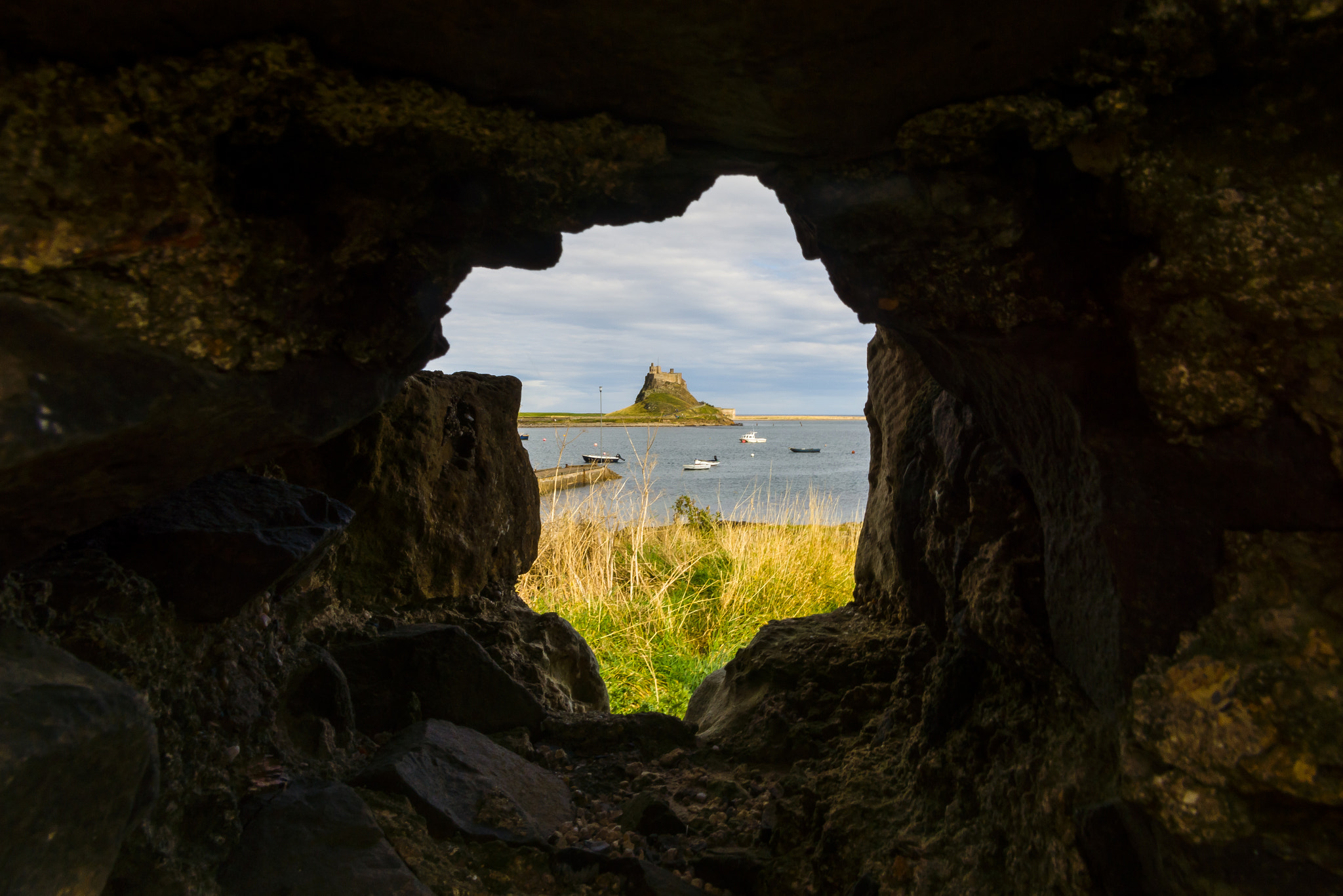 Sony SLT-A65 (SLT-A65V) sample photo. Lindisfarne castle through rock photography