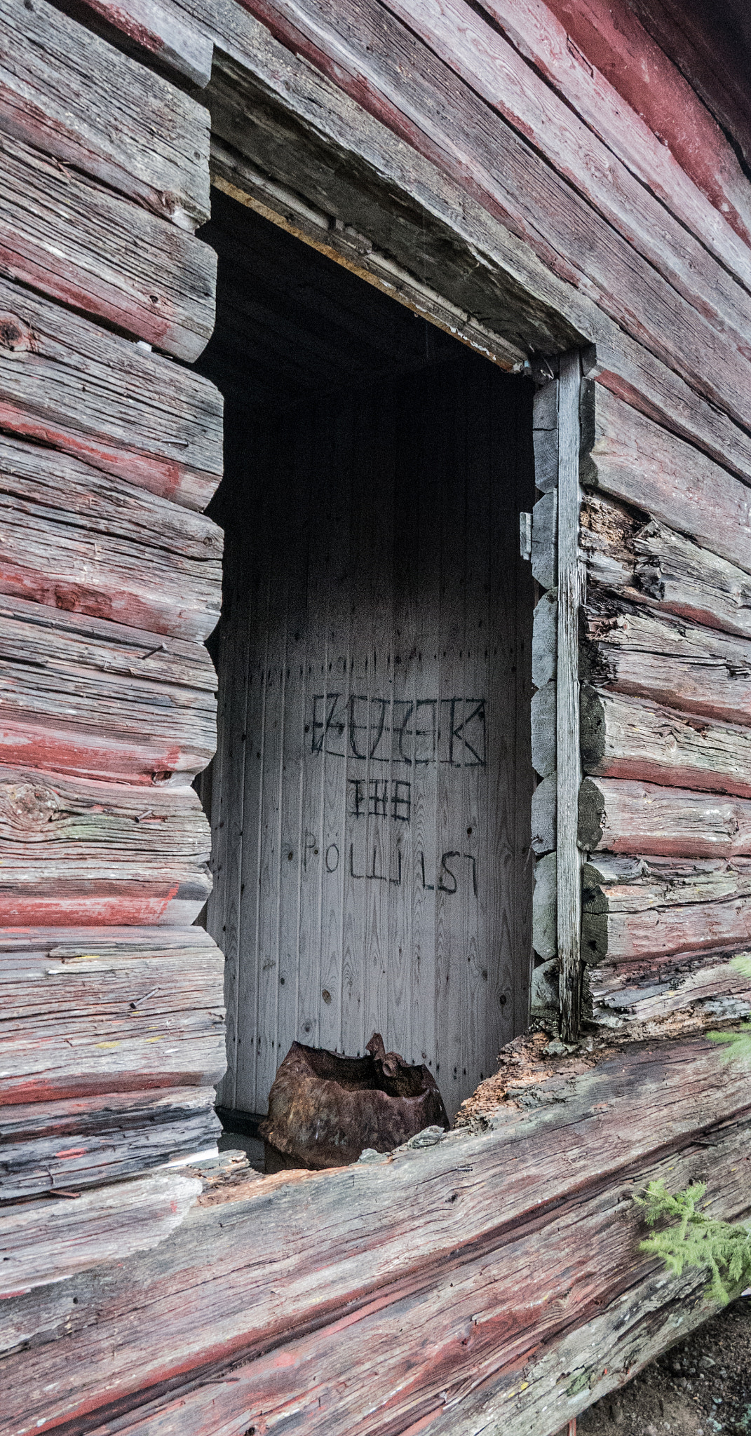 Panasonic Lumix DMC-GX7 + LUMIX G VARIO PZ 14-42/F3.5-5.6 sample photo. Abandoned red barn with a statement on the wall photography