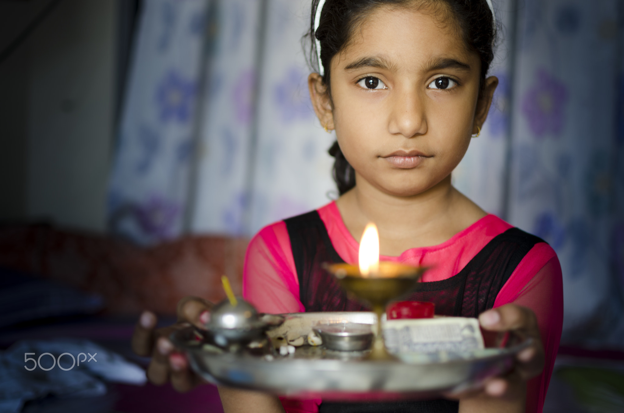 girl child portrait holding prayer plate welcoming