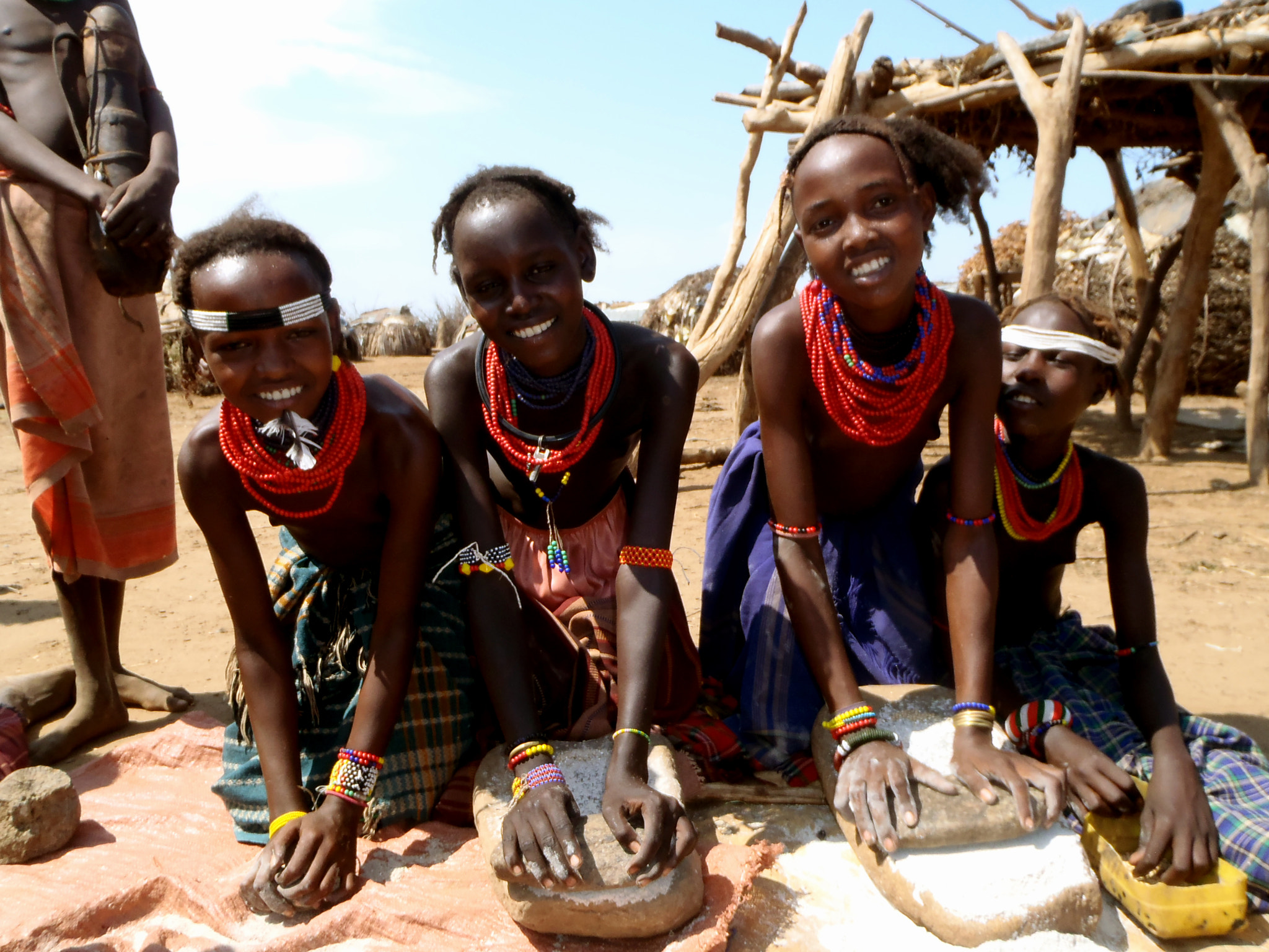 Olympus TG-310 sample photo. Dassanech girls grinding sorghum photography