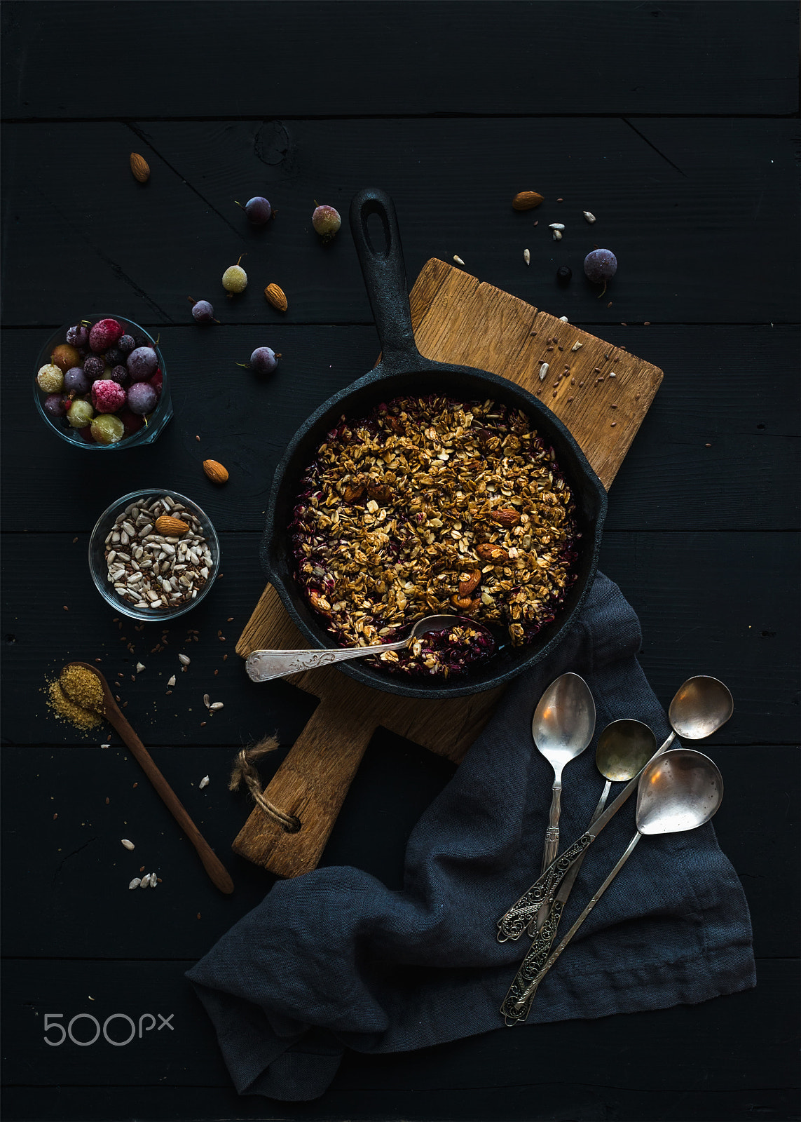 Nikon D610 + ZEISS Distagon T* 35mm F2 sample photo. Healthy breakfast. oat granola crumble with frozen fresh berries, and seeds in irom skillet pan on r photography