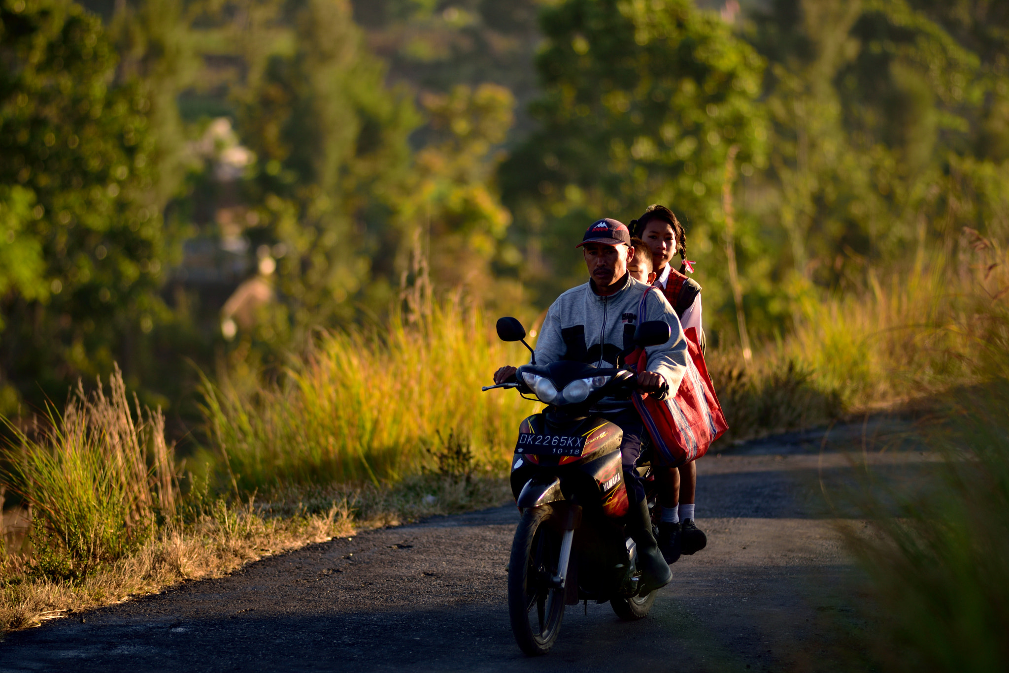 Nikon D750 + Nikon AF Nikkor 180mm F2.8D ED-IF sample photo. Villager on bike photography