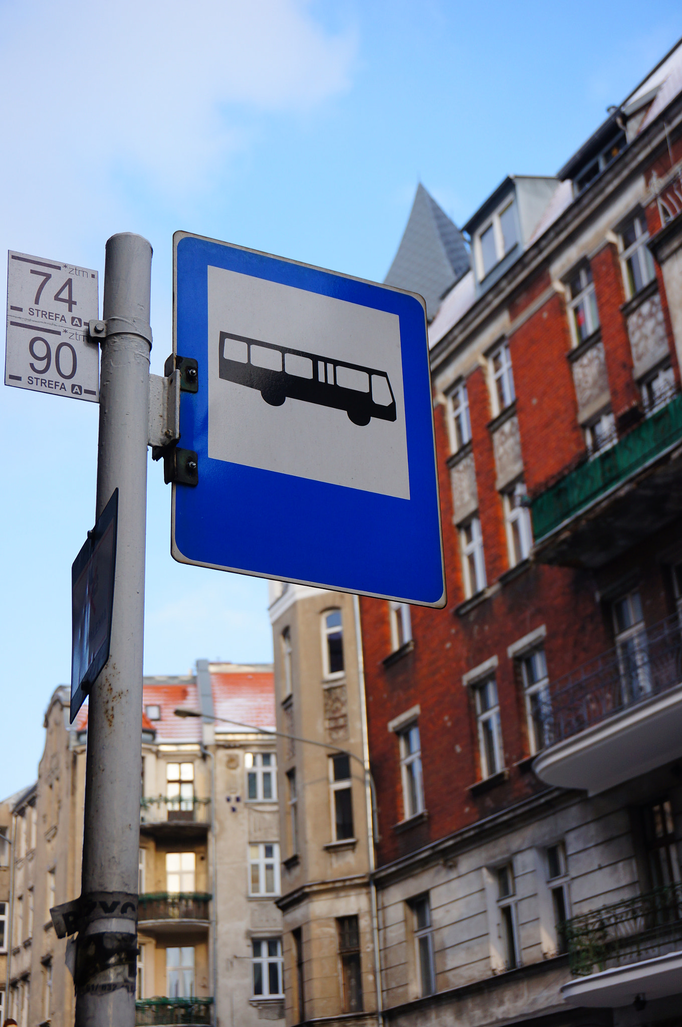 Sony Alpha NEX-5N + Sony E 18-50mm F4-5.6 sample photo. Poznan, poland - january 26, 2014: bus stop sign by the center of the city photography