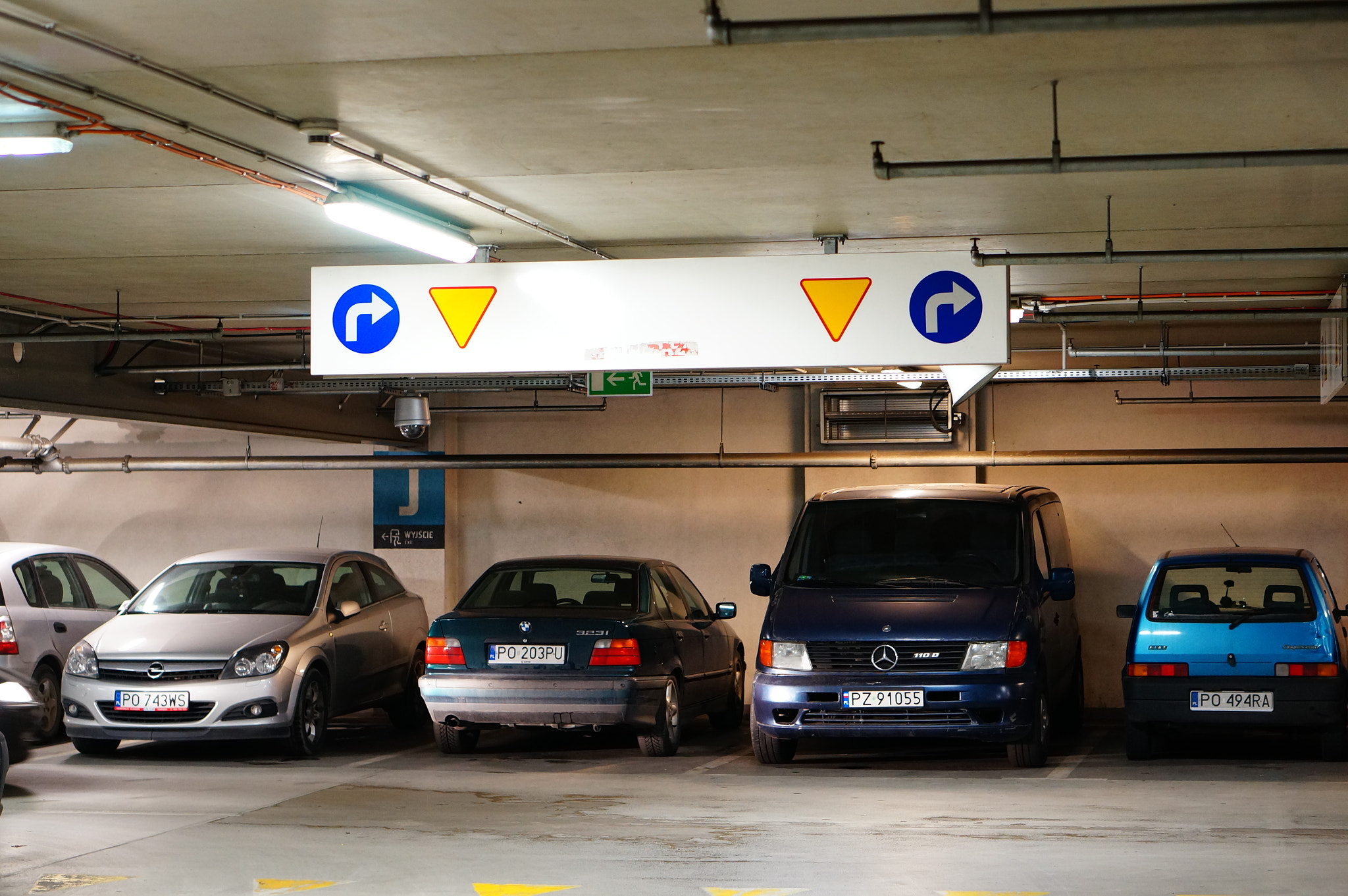 Sony Alpha NEX-6 + Sony E 50mm F1.8 OSS sample photo. Poznan, poland - november 26, 2013: parked cars in the parking garage of the shopping mall malta photography