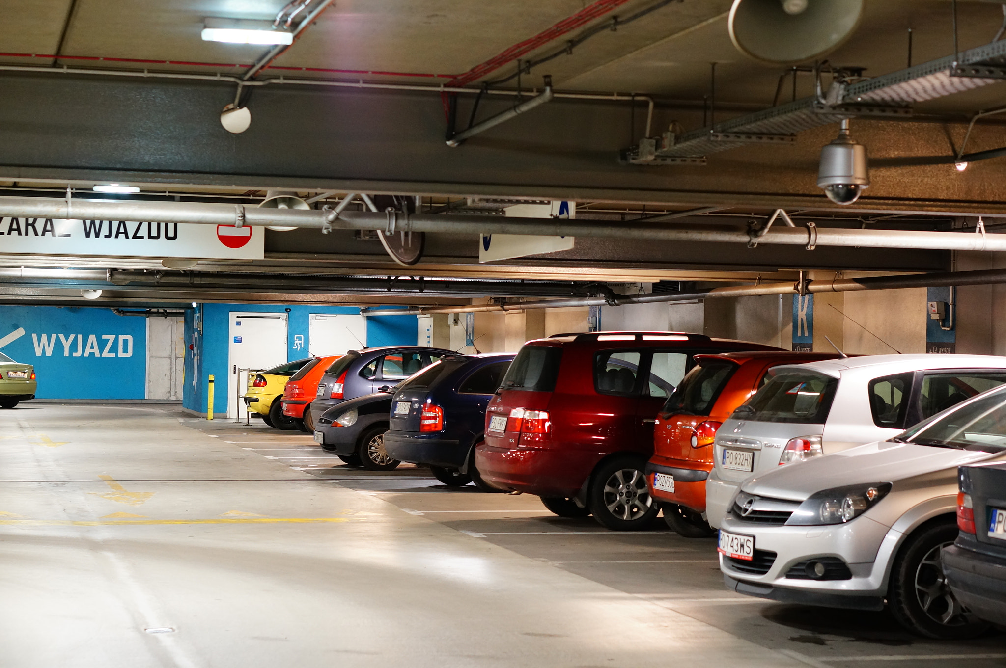 Sony Alpha NEX-6 + Sony E 50mm F1.8 OSS sample photo. Poznan, poland - november 26, 2013: parked cars in the parking garage of the shopping mall malta photography
