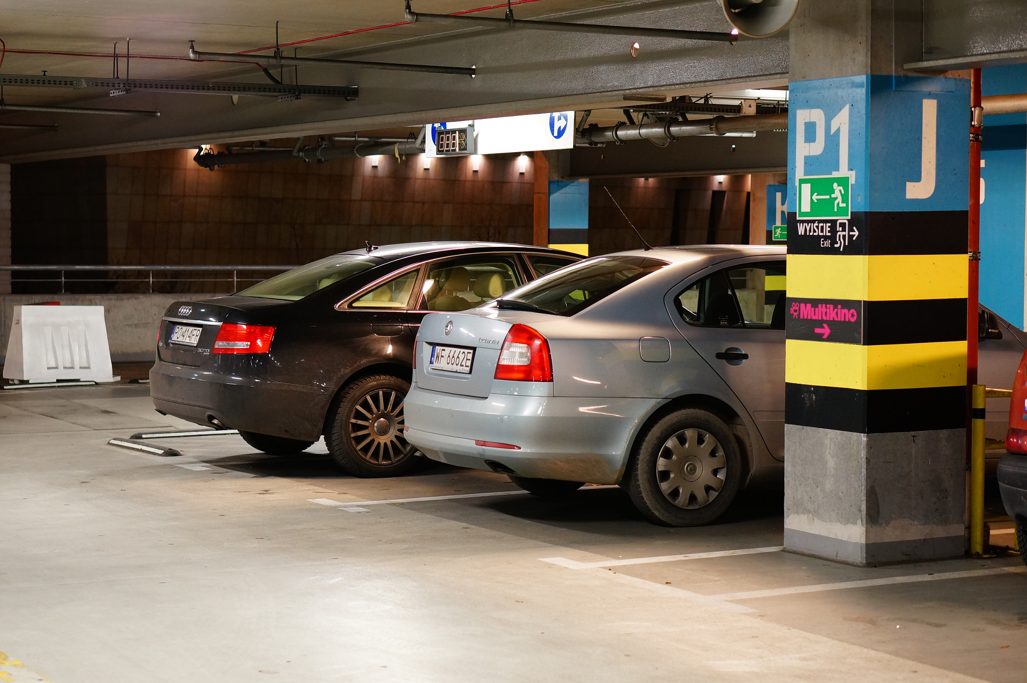 Sony Alpha NEX-6 + Sony E 50mm F1.8 OSS sample photo. Poznan, poland - november 26, 2013: parked cars in the parking garage of the shopping mall malta photography