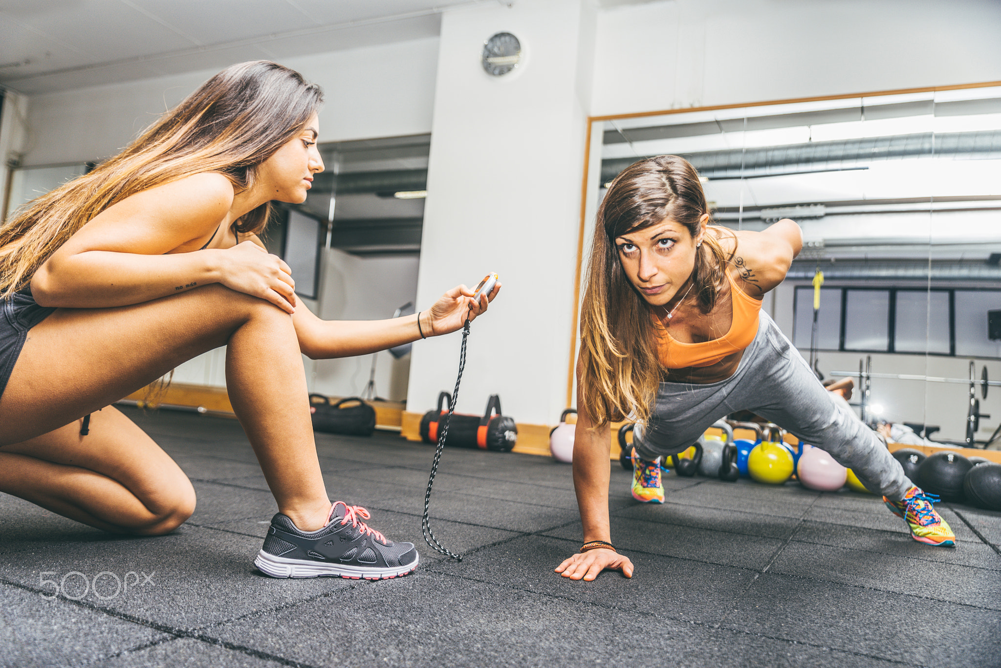 Woman doing pushups in a gym