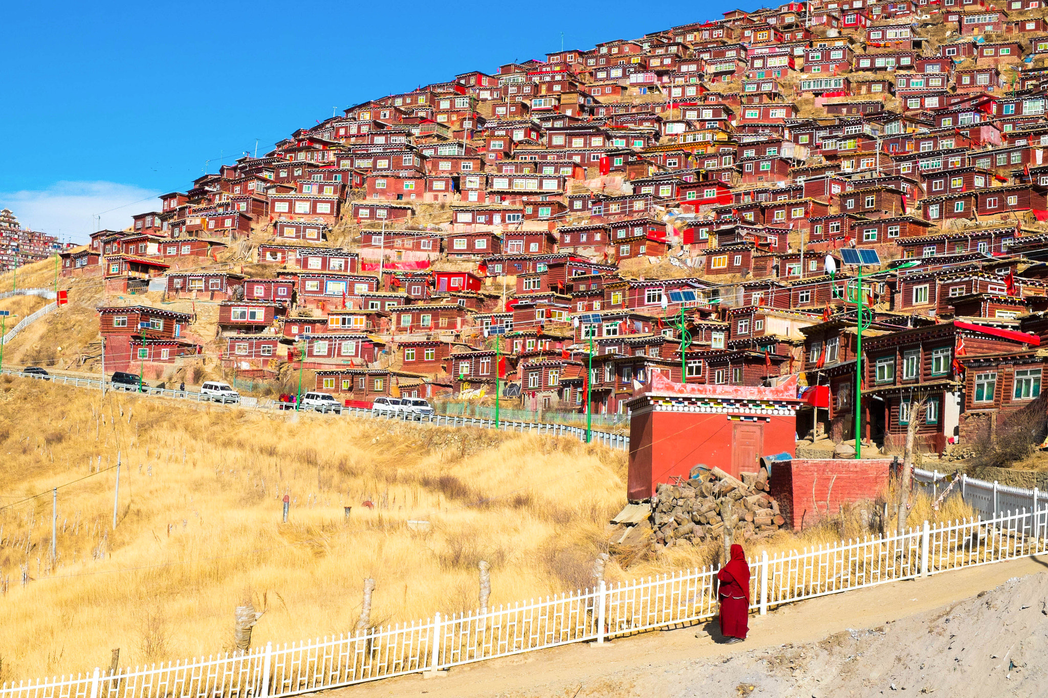 A nun looking at her house on the hill