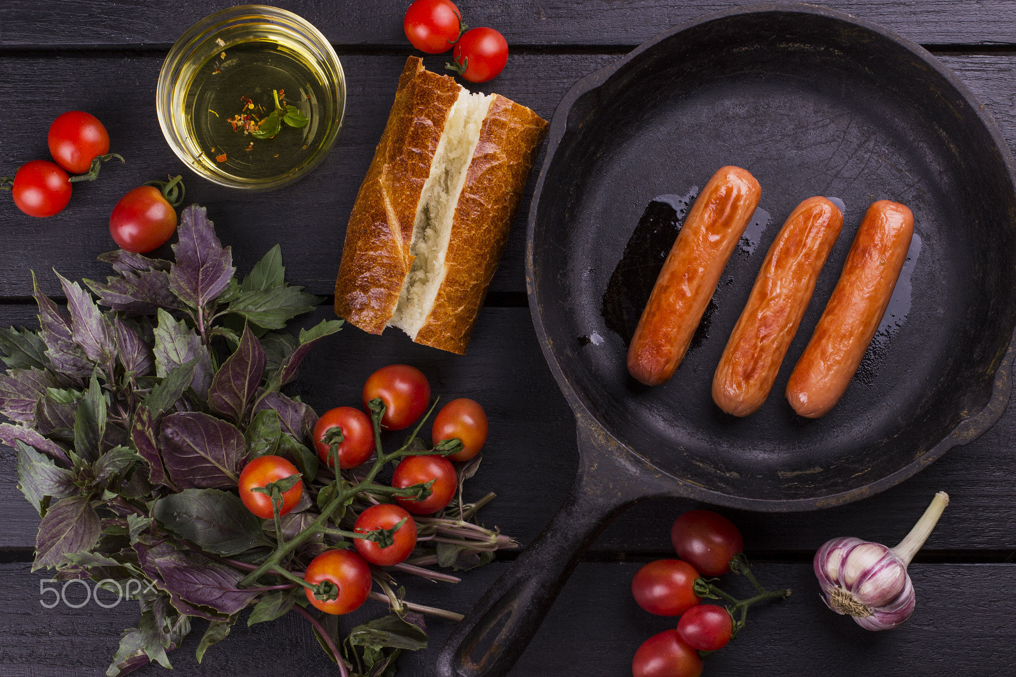 Ingredients for hot dog: bread, sausage, tomatoes, basil, garlic