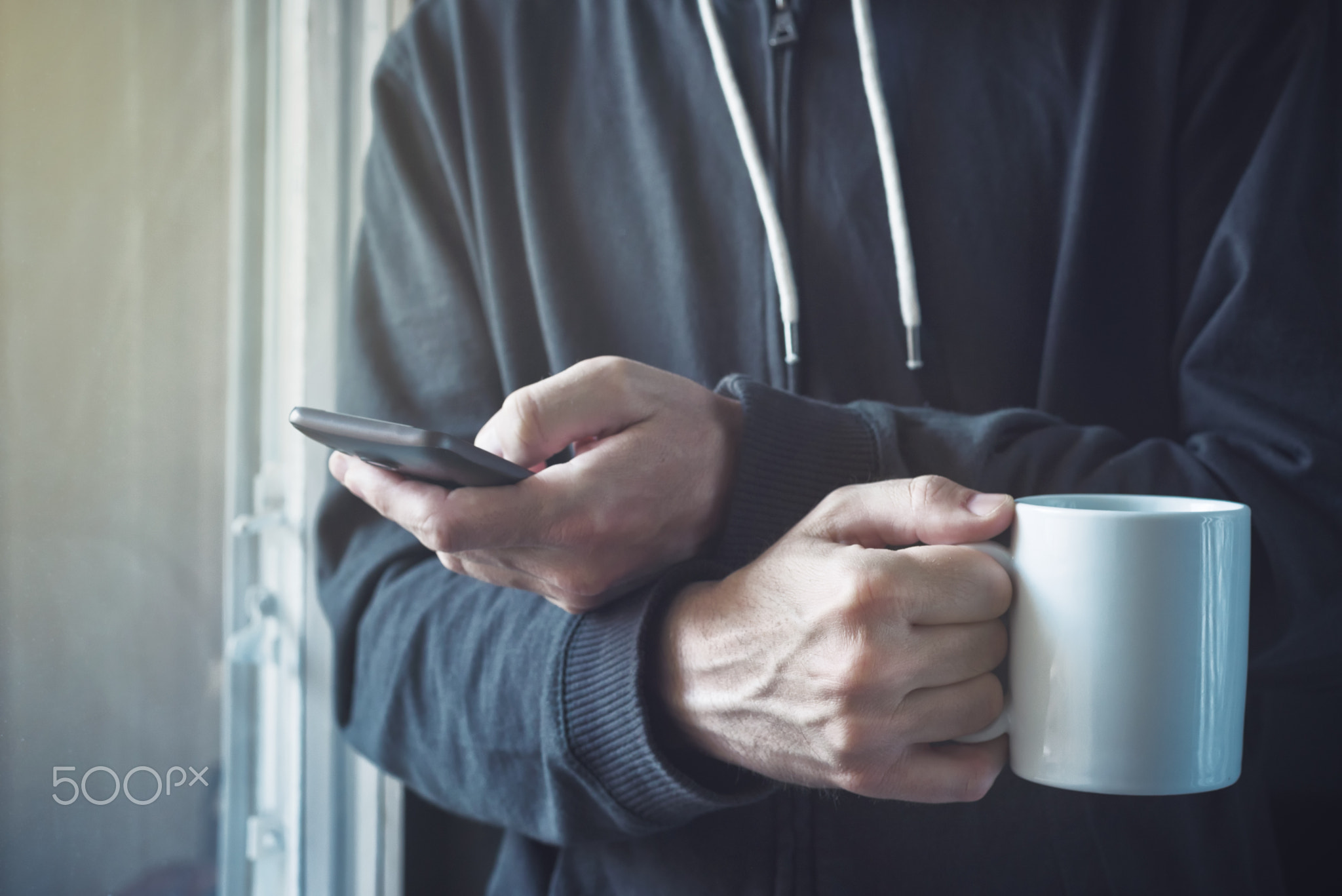 Drinking Coffee And Texting with Mobile Phone in Morning