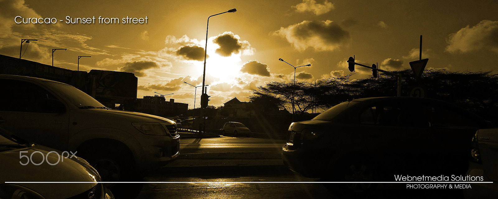 Nikon D5100 + Nikon AF Nikkor 85mm F1.8D sample photo. Curacao sunset from street photography