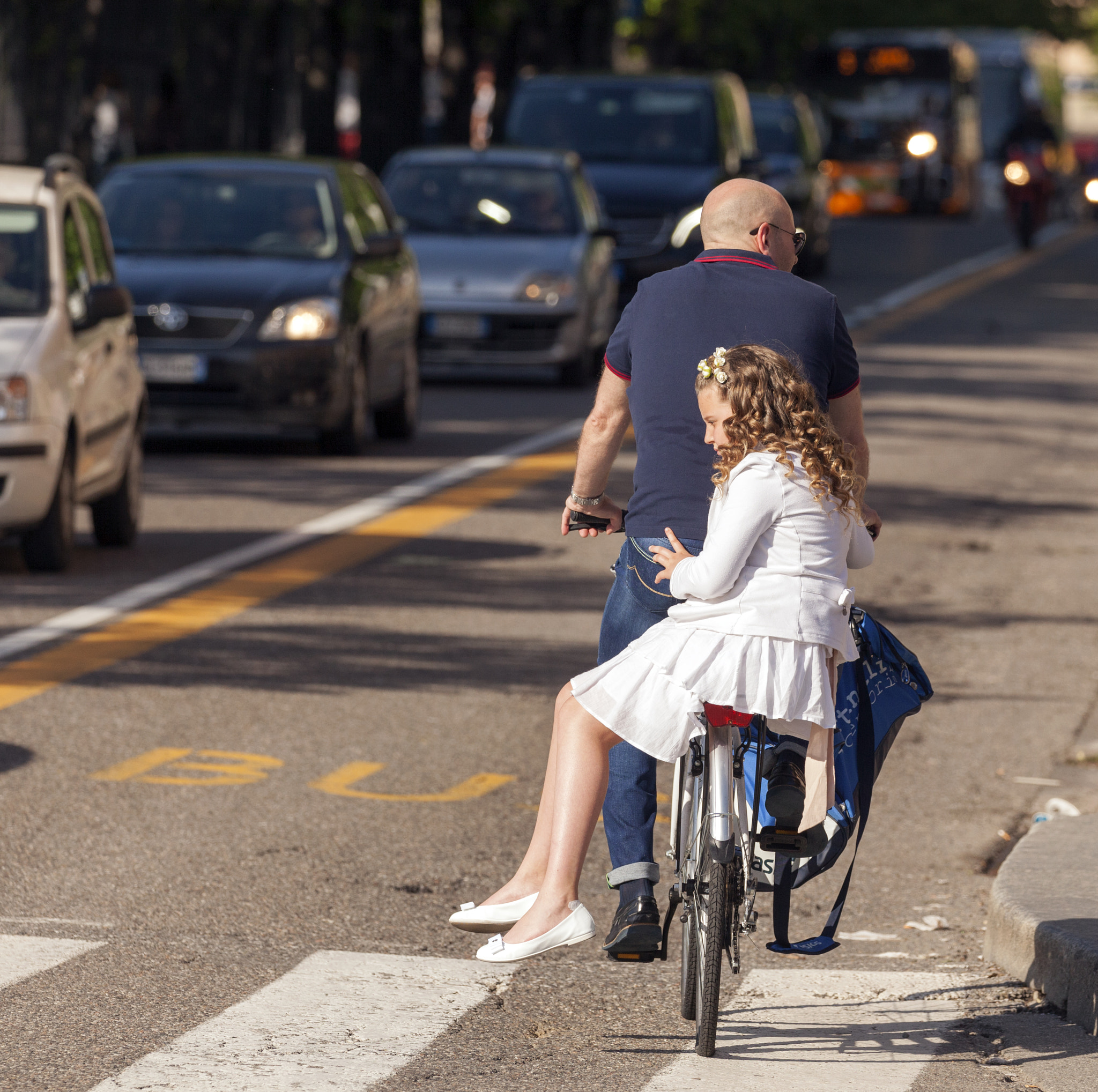 Canon EF 100-400mm F4.5-5.6L IS II USM sample photo. Girl in white as passenger on a bike photography