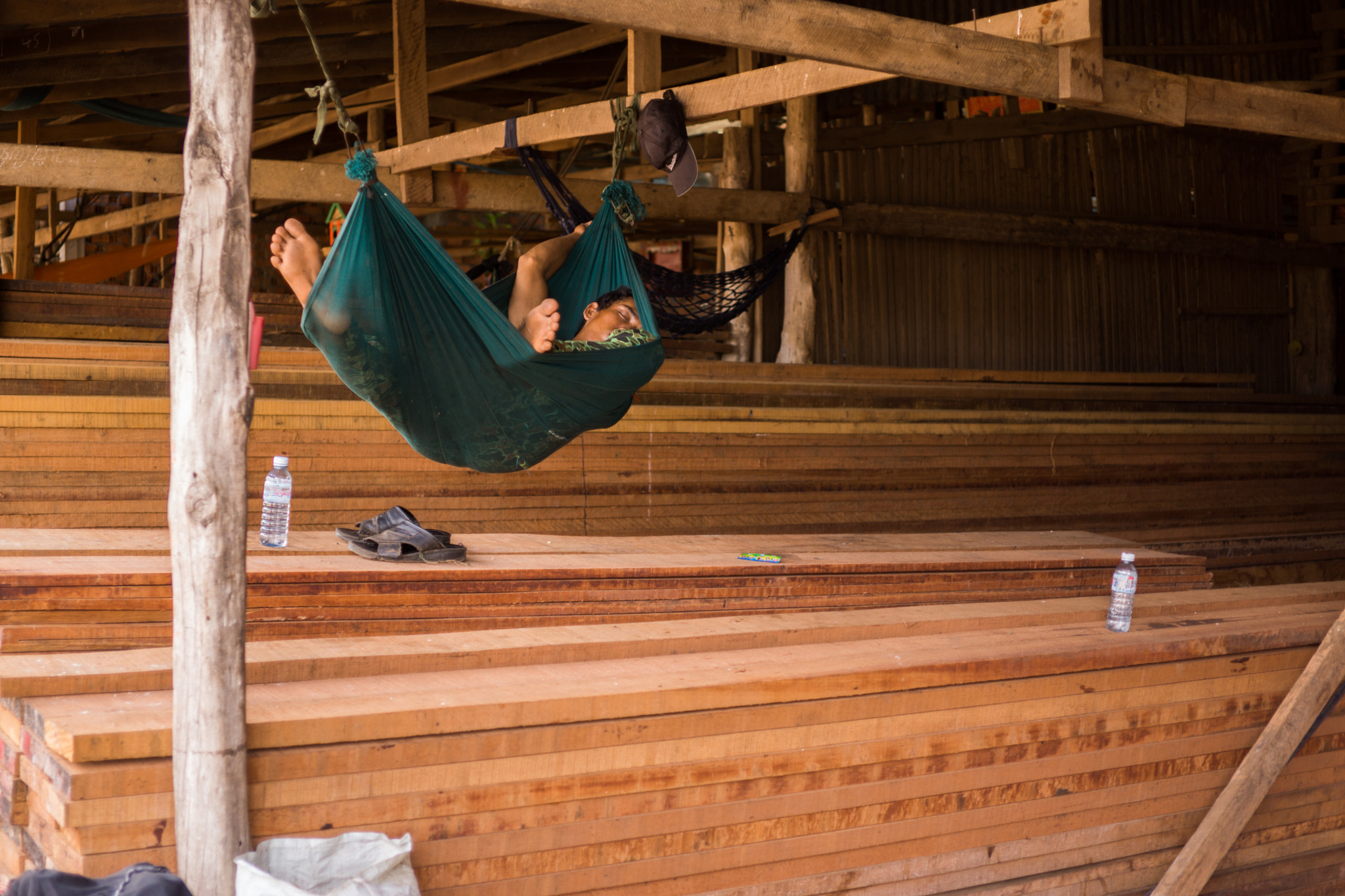 E 32mm F1.8 sample photo. Sleeping in the wood warehouse photography