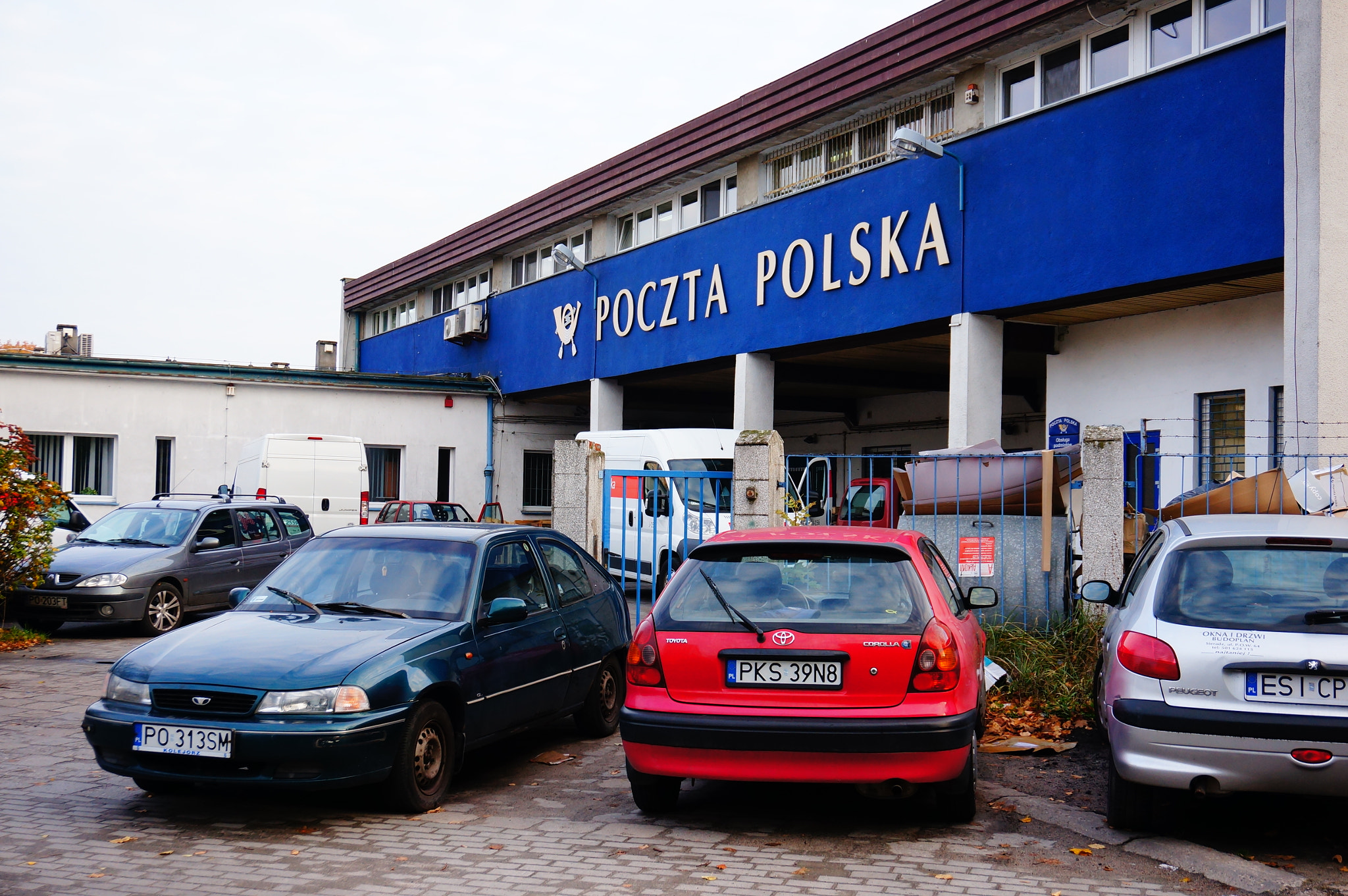 Sony E 16-50mm F3.5-5.6 PZ OSS sample photo. Poznan, poland - october 16, 2013: parked cars in front of a post office photography