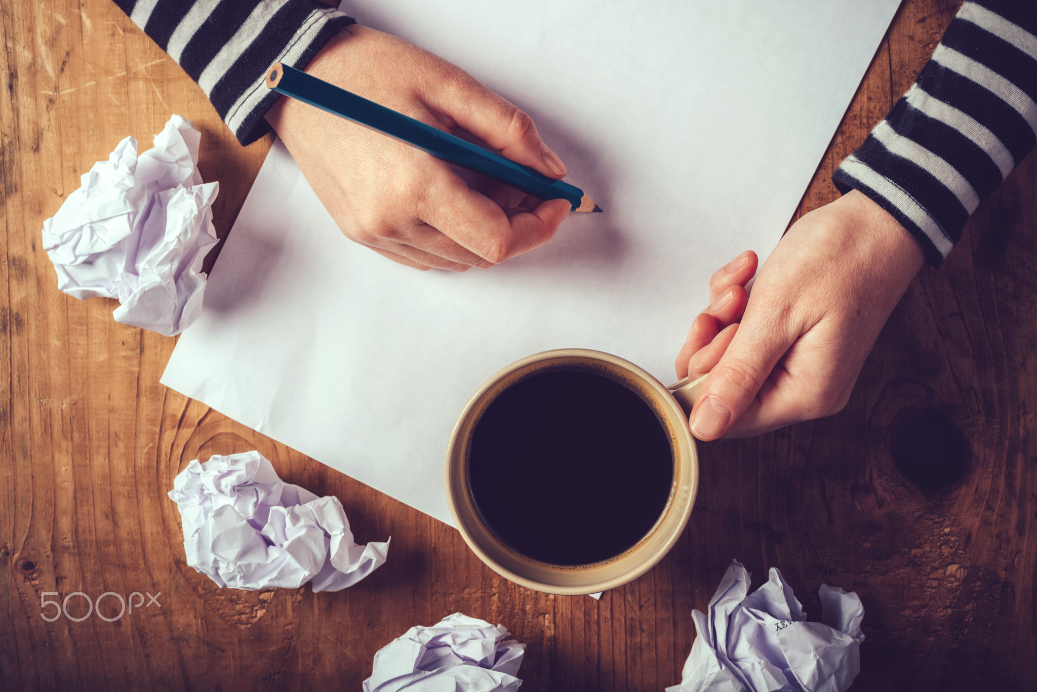 Female writer drinking cup of coffee