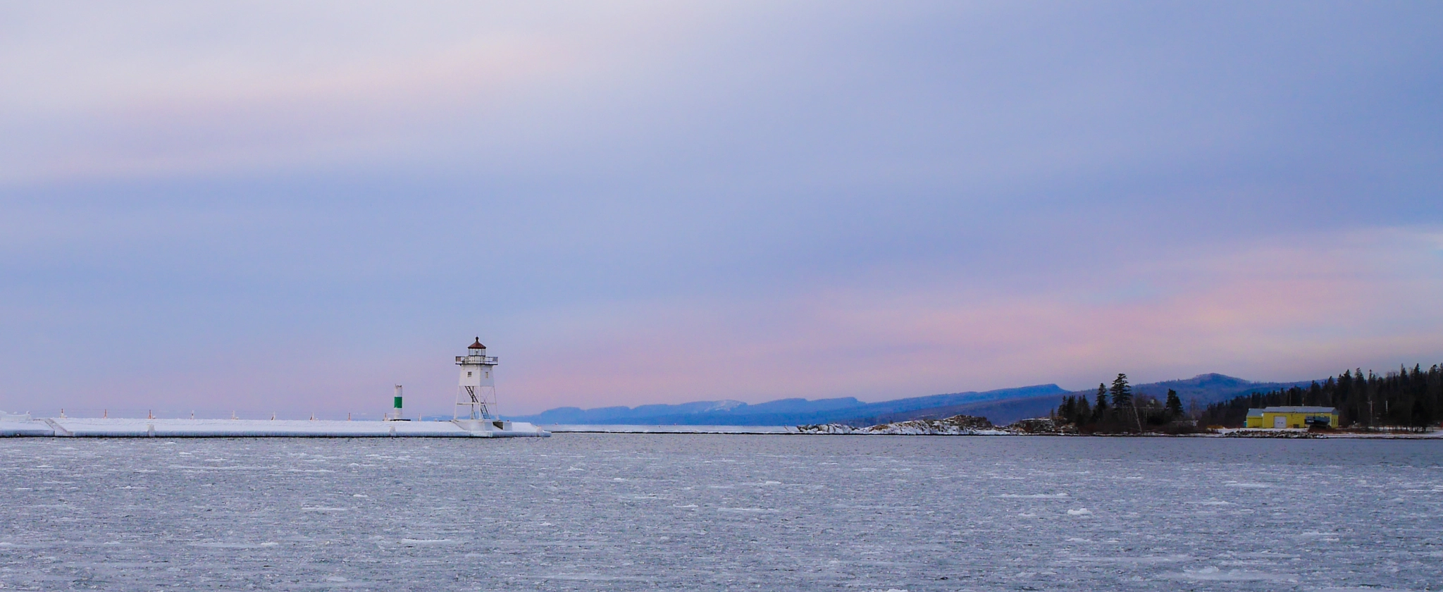 Panasonic Lumix DMC-GX7 + Olympus M.Zuiko Digital 25mm F1.8 sample photo. Lighthouse overlooking a frozen lake photography