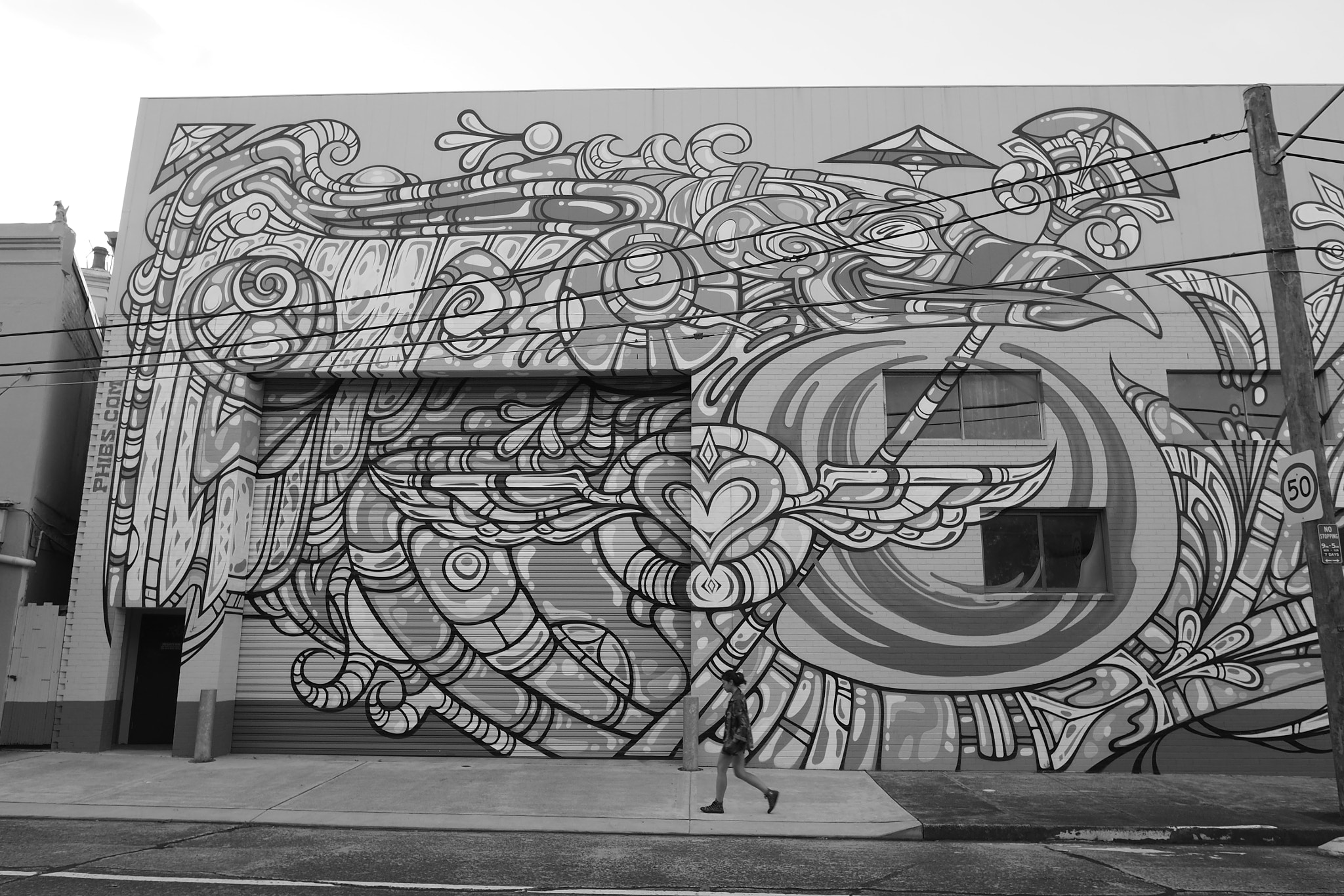 Olympus OM-D E-M5 II + OLYMPUS M.12mm F2.0 sample photo. Walking with graffiti photography