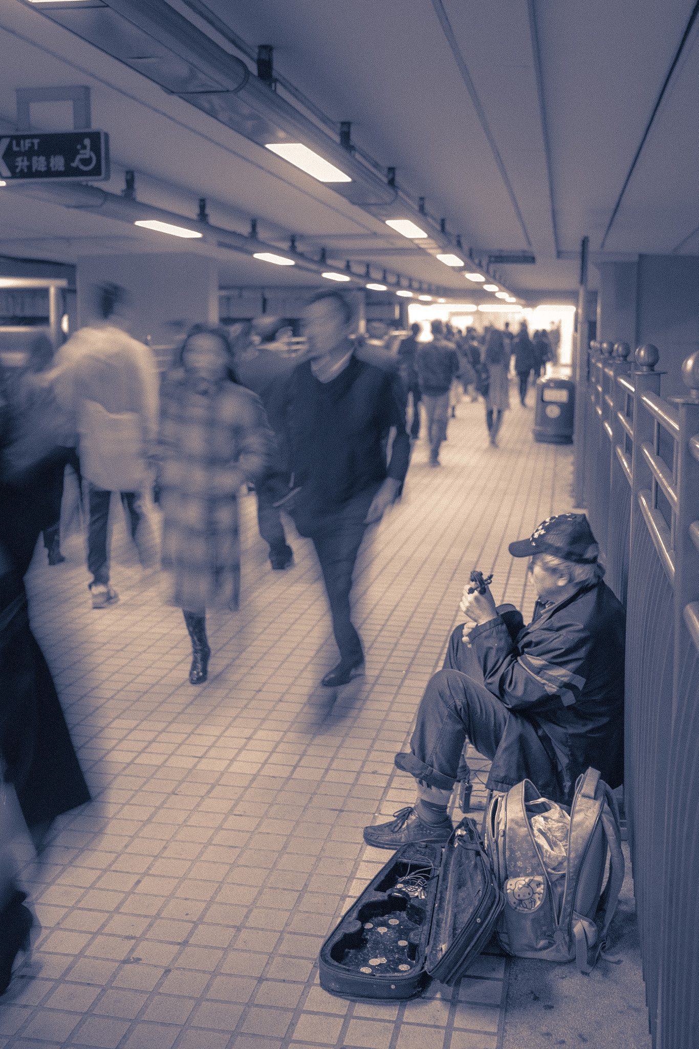 Sony a7 + FE 35mm F0 ZA sample photo. Old street performer on a bridge to the railway station in hong kong photography