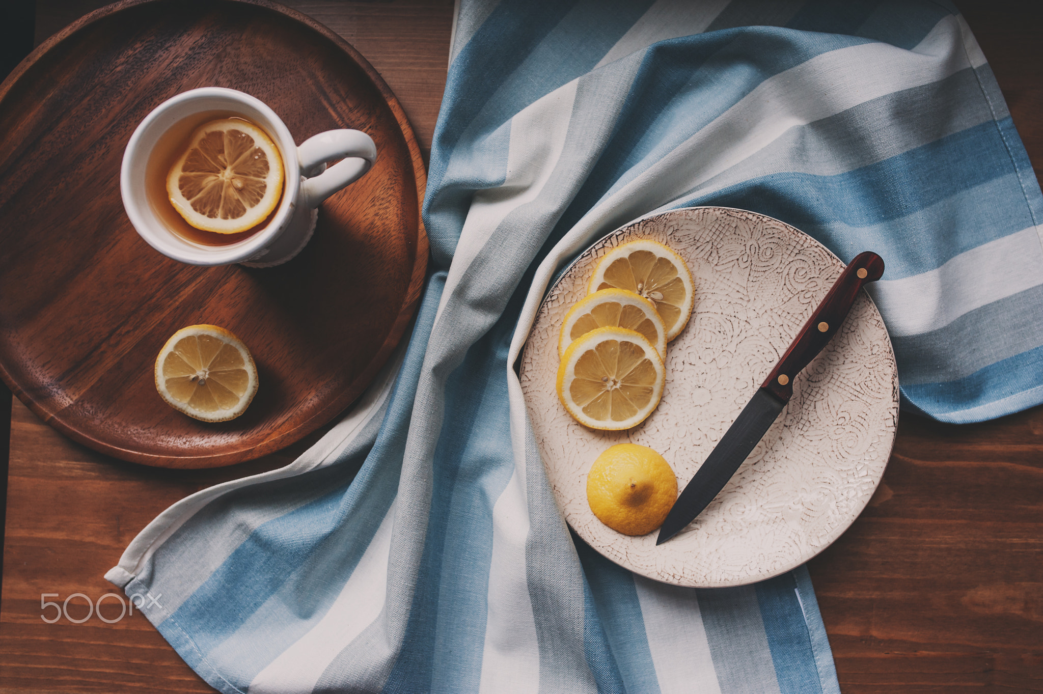 hot tea with lemon slices on wooden table, top view